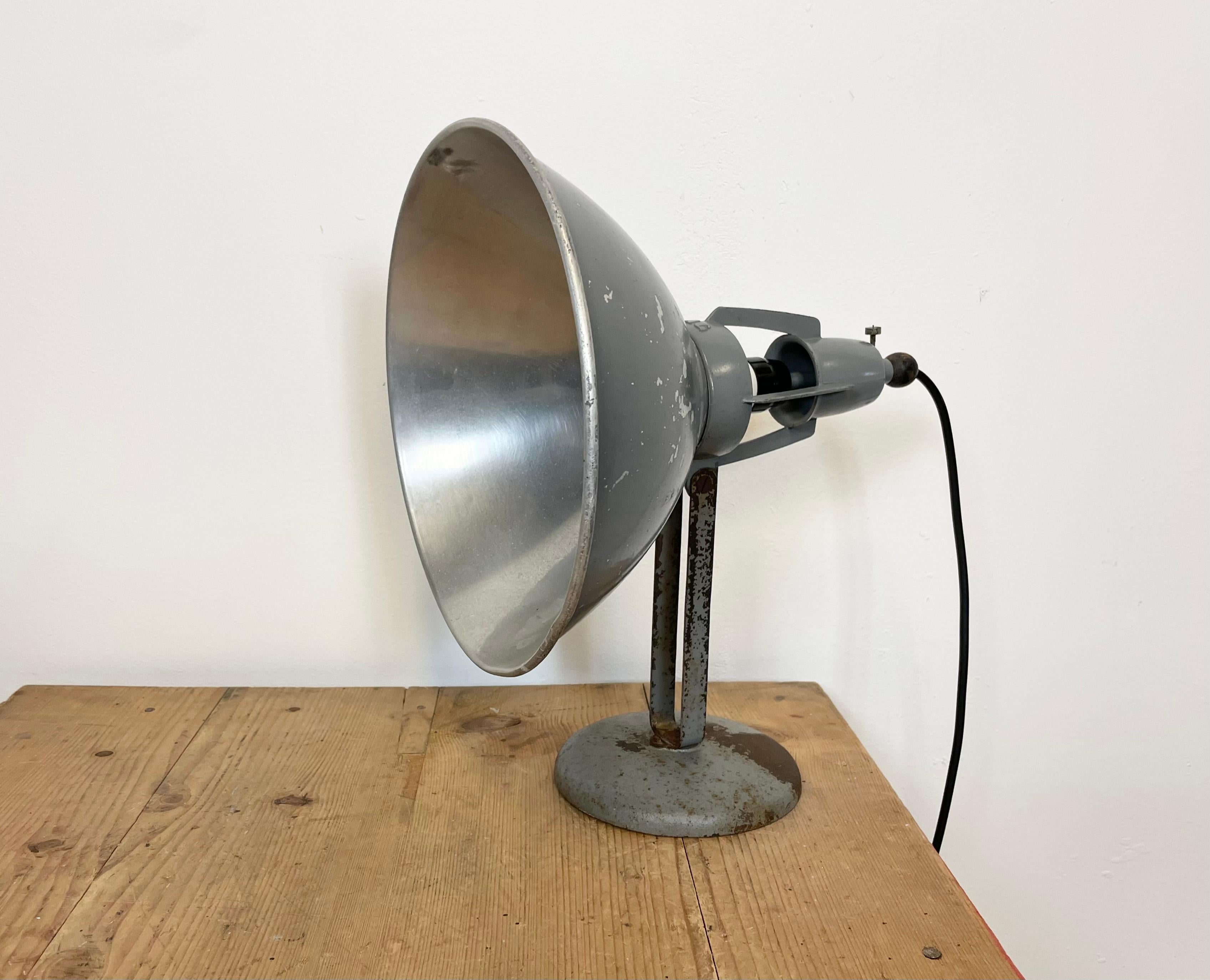 - Industrial table lamp manufactured in Switzerland by BAG Turgi during the 1950s
- Iron base and adjustable aluminum shade
- New porcelain socket requires E 27 light bulbs
- New wire.