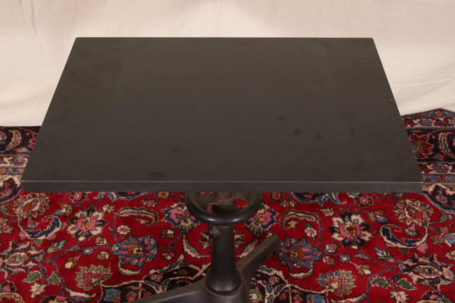 Industrial style table with Carl Zeiss base and formica top, black painted iron adjustable tripod base with a rectangular black formica top. 

Condition: Expected wear and signs of use including some areas of rust to base, light surface scratching