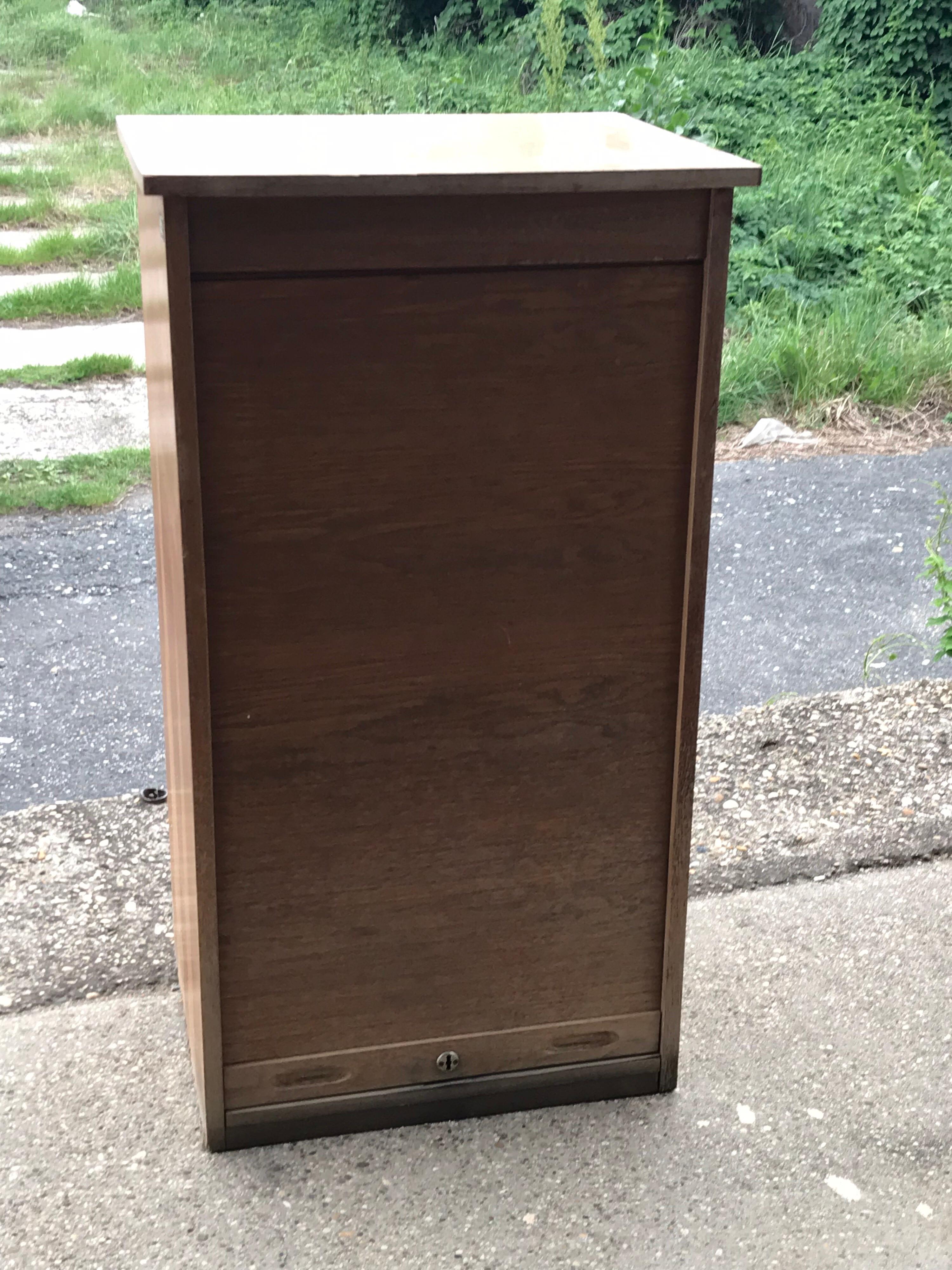 Industrial tambour front cabinet.
Mid-20th century Hungarian Industrial tambour front filing cabinet with adjustable shelving.