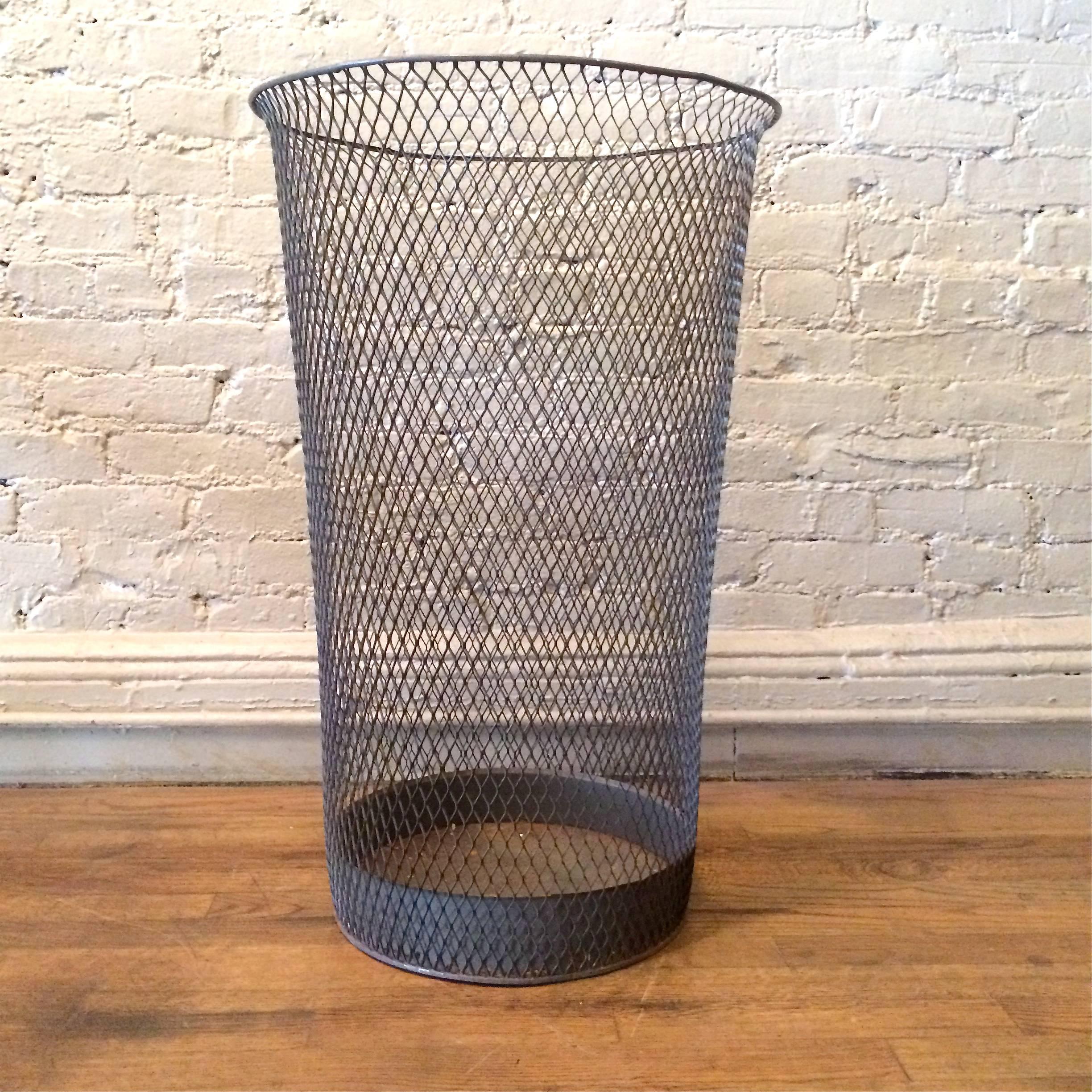 Industrial, fine weave, steel, metal mesh basket tapers from 12 inches at the bottom to 18 inches on top with a curved lip edge.