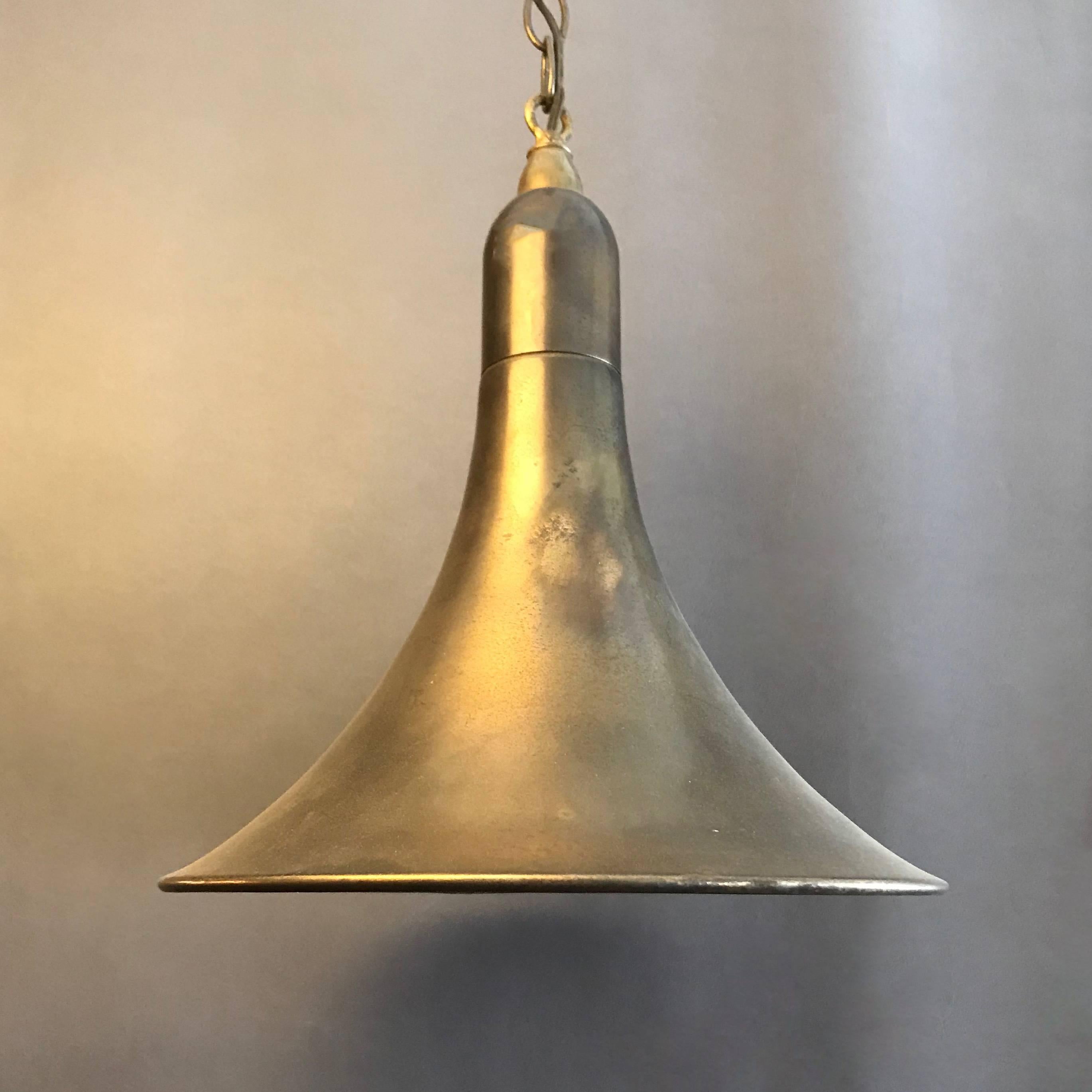 Industrial pendant light features a tapered, funnel-shape shade in gunmetal finish that is newly wired with brass chain and canopy.