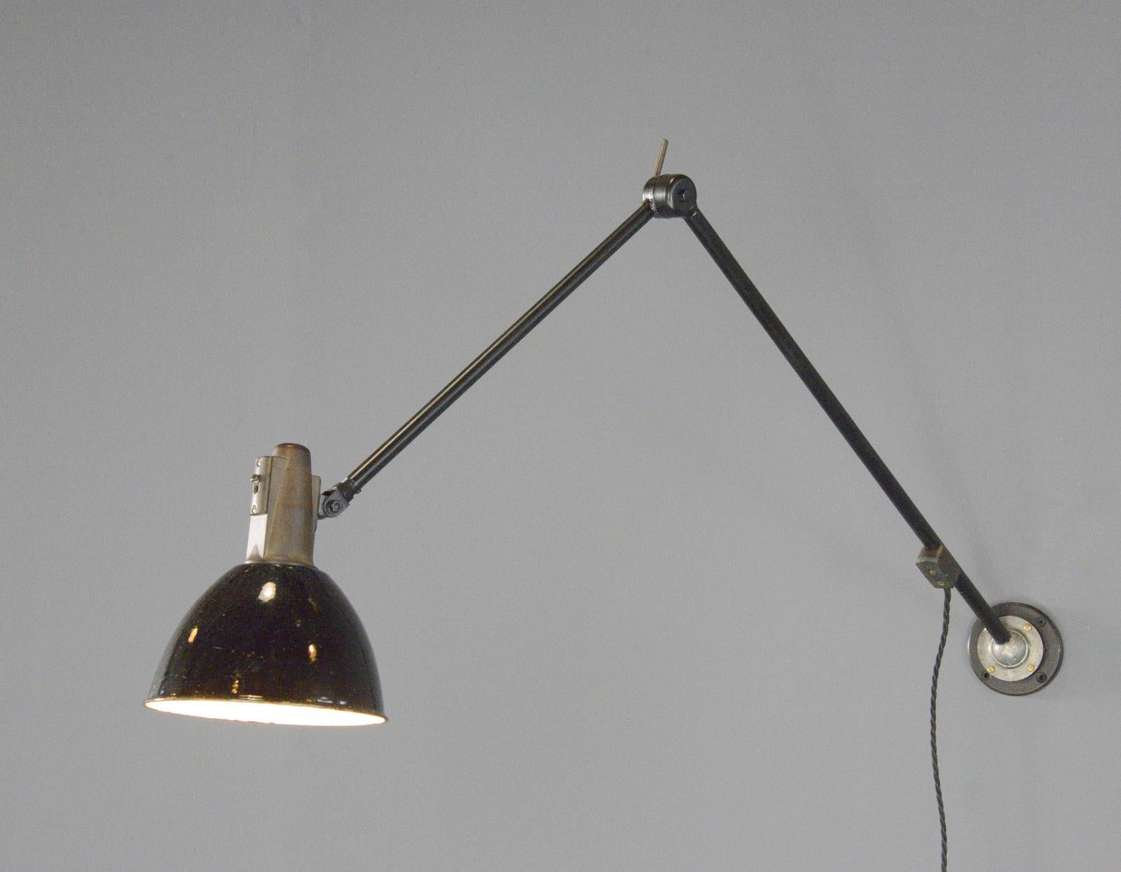 Industrial Task Lamp By Willhelm Bader Circa 1930s

- Black enamel shade
- Original bakelite head with On/Off switch
- Articulated arms
- Takes E27 fitting bulbs
- By Willhelm Bader
- German ~ 1930s
- 17cm wide 
- Extends up to 130cm from the