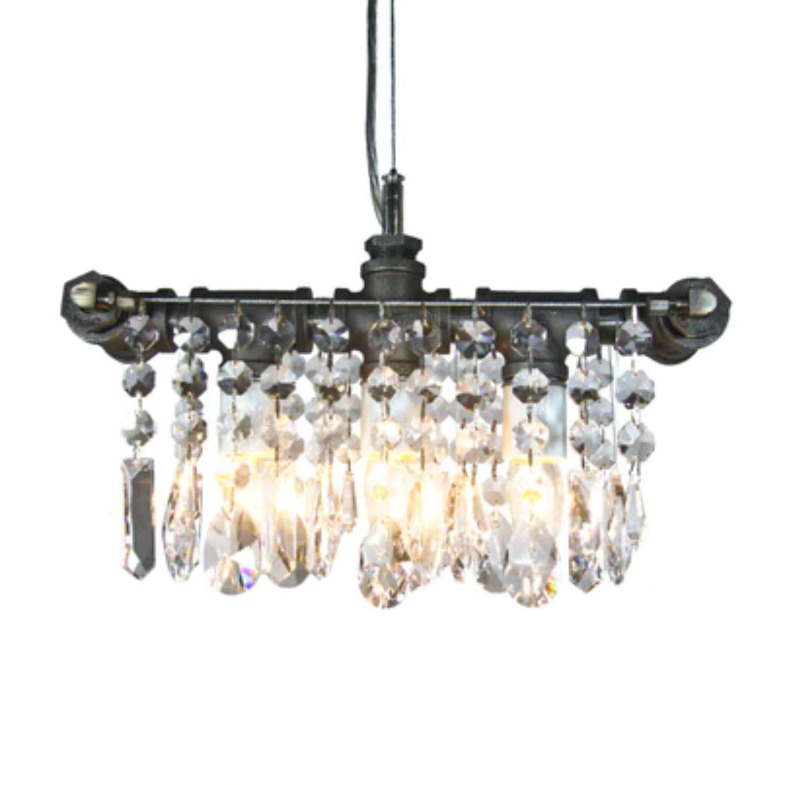 Industrial three bulb chandelier pendant by Michael McHale.
Dimensions: D 11.5 x W 35.5 x H 20 cm.
Materials: steel, optically-pure gem-cut crystal.

3 x medium base CA7 bulb, either incandescent or LED

All our lamps can be wired according to