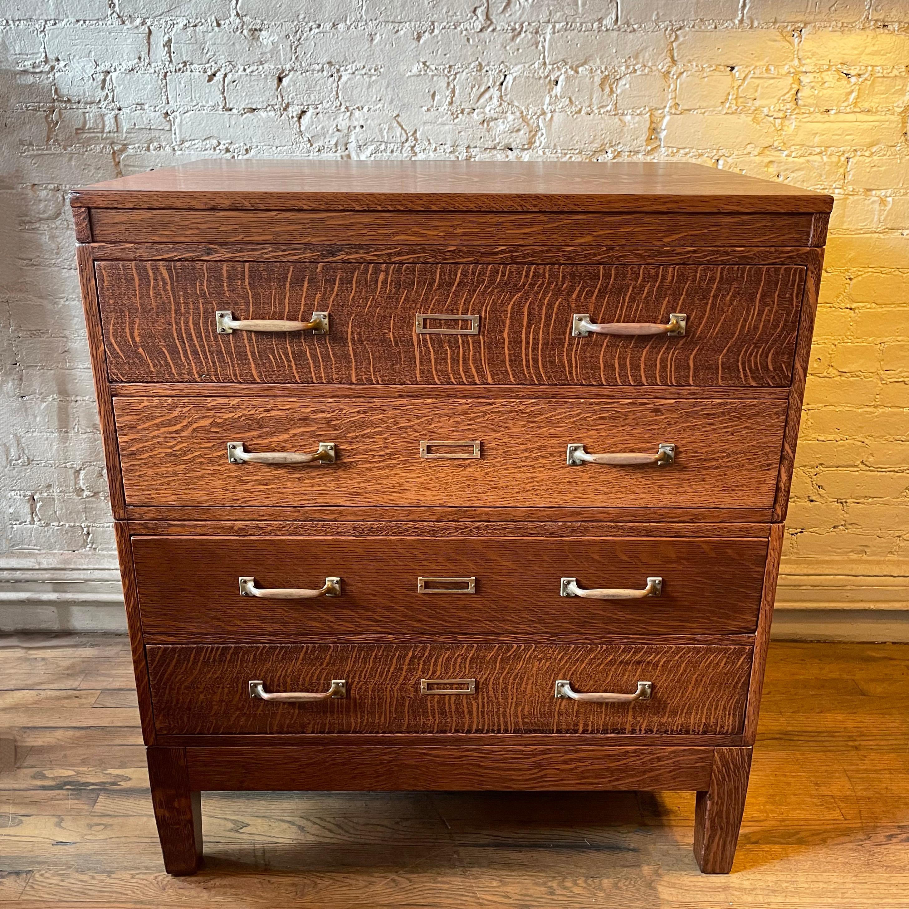 Handsome, early 20th century, industrial, tiger oak, modular, document cabinet by Library Bureau Makers features four drawers at 5.5 inches height each with brass plates and handles.