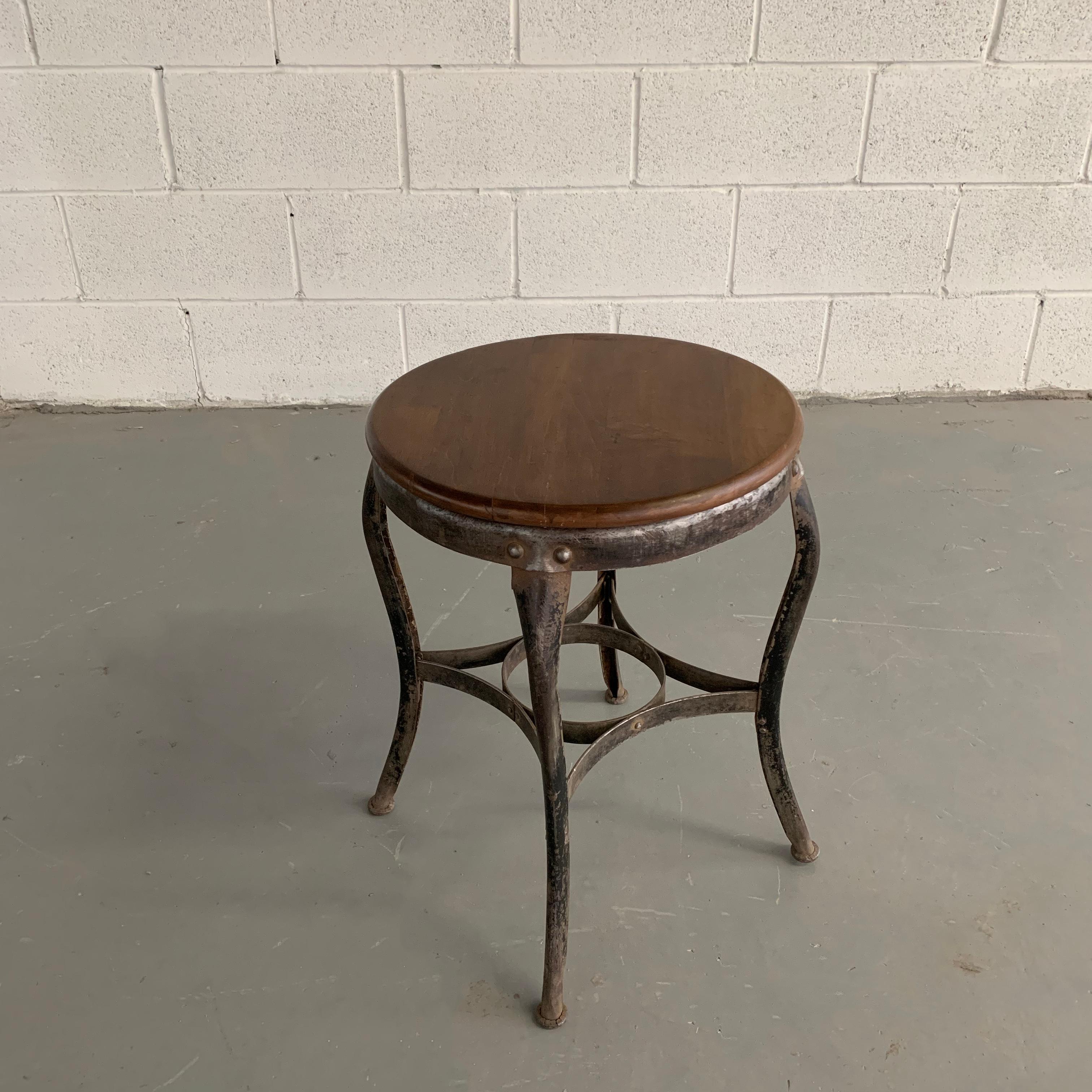 Industrial, 1940s shop stool by Toledo Metal Furniture Co. features a steel frame with 19 inch round walnut seat.