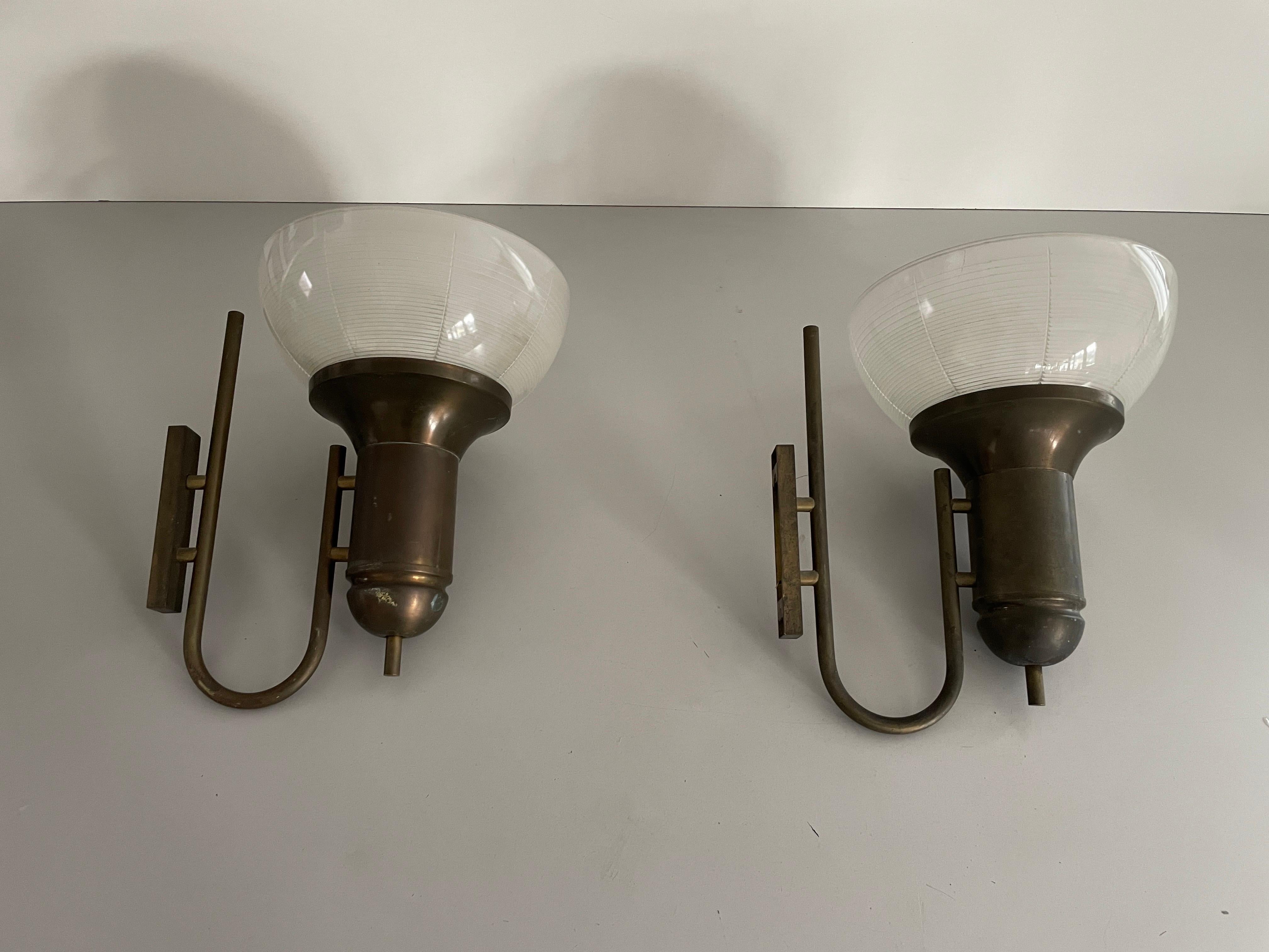 Industrial Type Glass & Brass Large Pair of Sconces, 1950s, Italy

Very nice high quality wall lamps.


These lamps works with  E27 standard light bulbs. 
Wired and suitable to use in all countries. (110-220 V)

Dimensions:
Height: 35 cm
Width: 26
