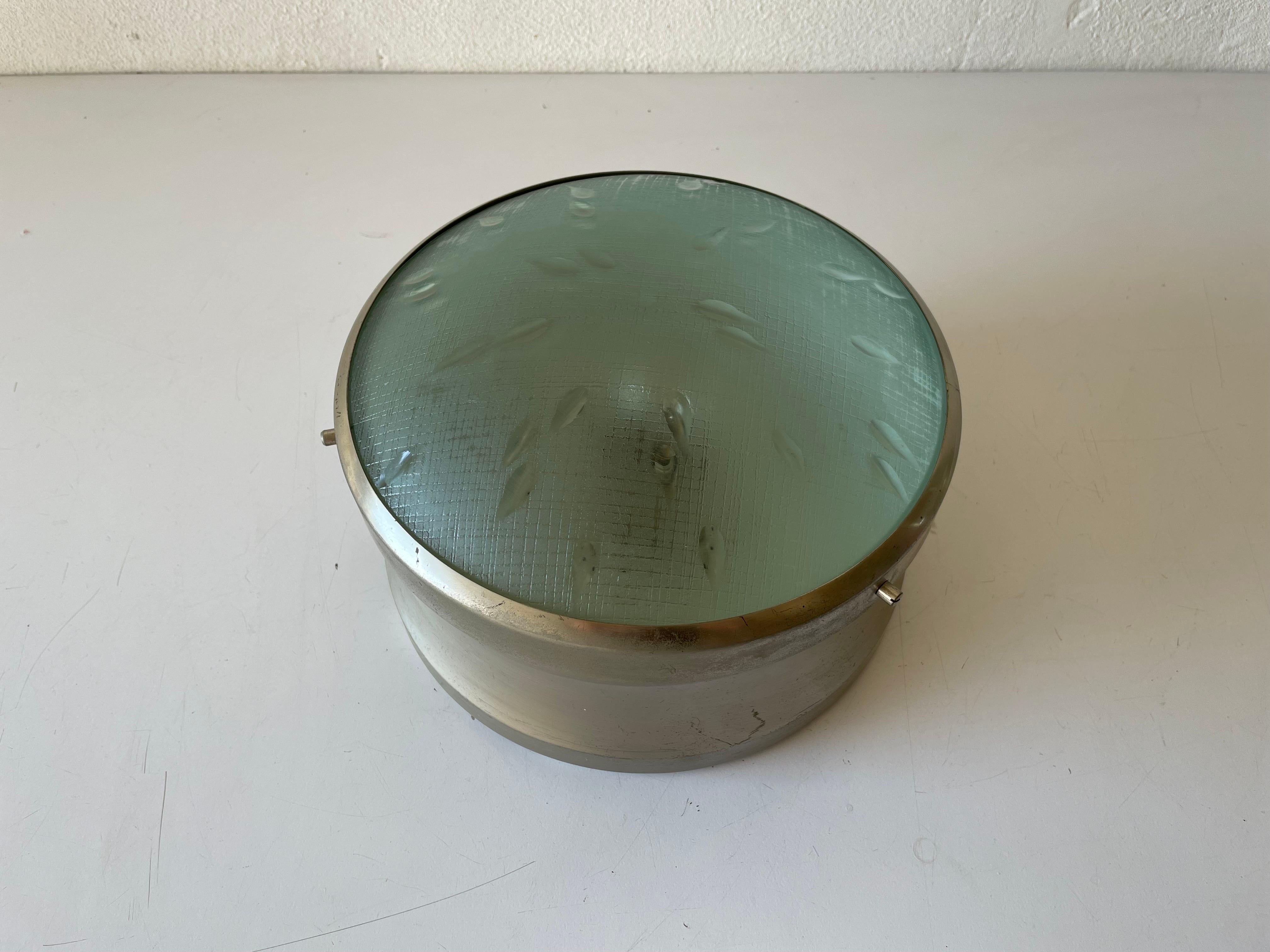 Industrial type green glass flush mount light, 1960s, Italy

Lampshade is in good condition and very clean. 
This lamp works with E27 light bulb. 
Wired and suitable to use with 220V and 110V for all countries.

Measures: 

Diameter: 23