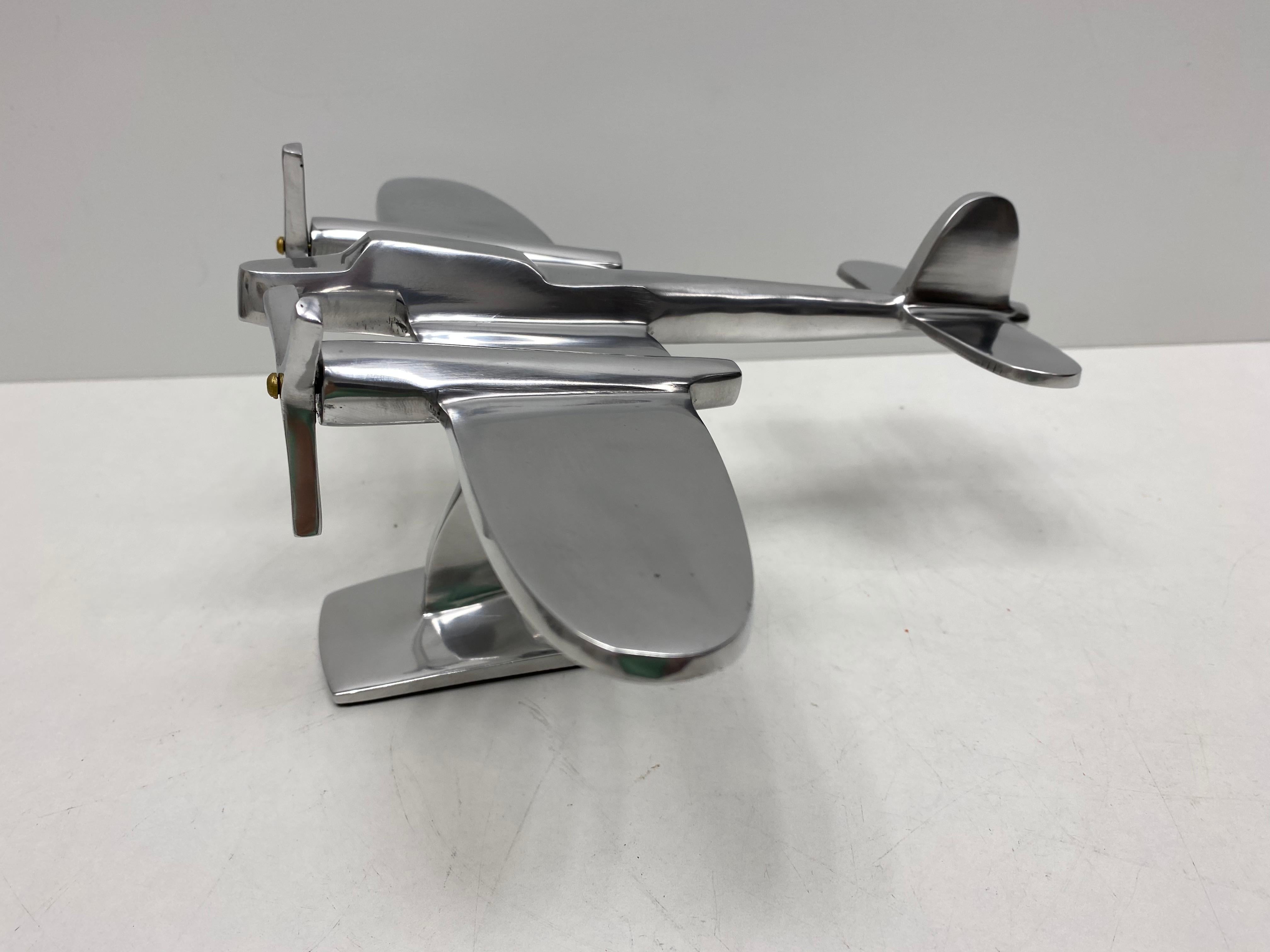 A Industrial plane model made in the 1980s. This unique object is made of metal, probably aluminum. A nice Industrial sculpture for displaying them on a cupboard, credenza or a desk.