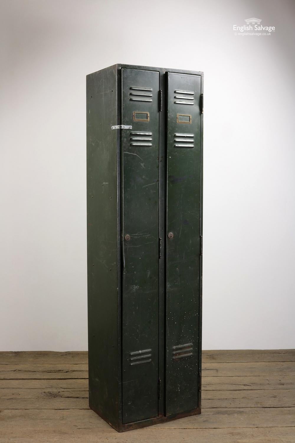 Reclaimed vintage Industrial style metal double locker, painted green. With name plate holders, an internal shelf in each locker and supports for an additional two shelves per locker.

No keys present, small holes in sides and back (likely to have