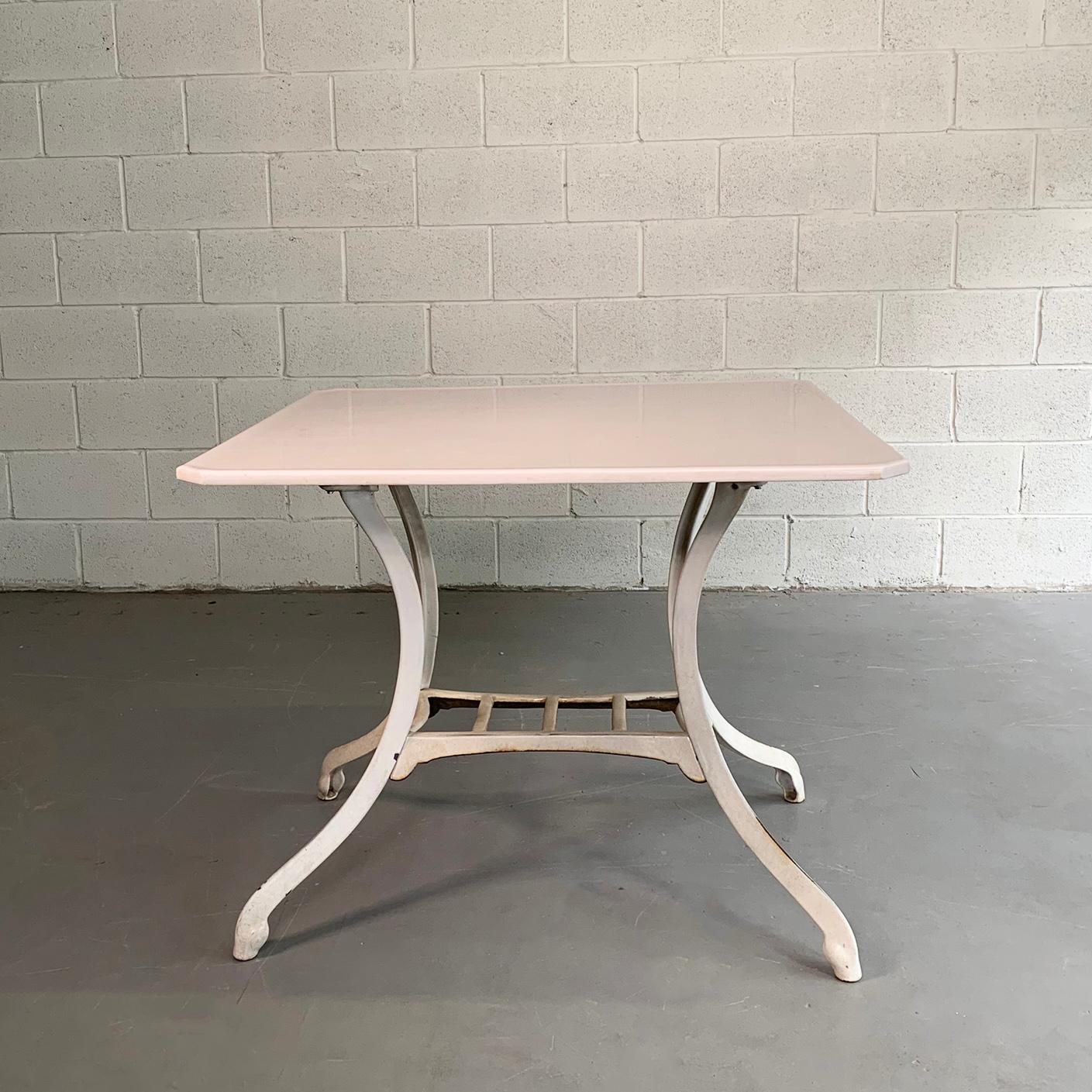 Industrial, early 20th century table features an enameled, cast iron base with milk white, Vitrolite top.