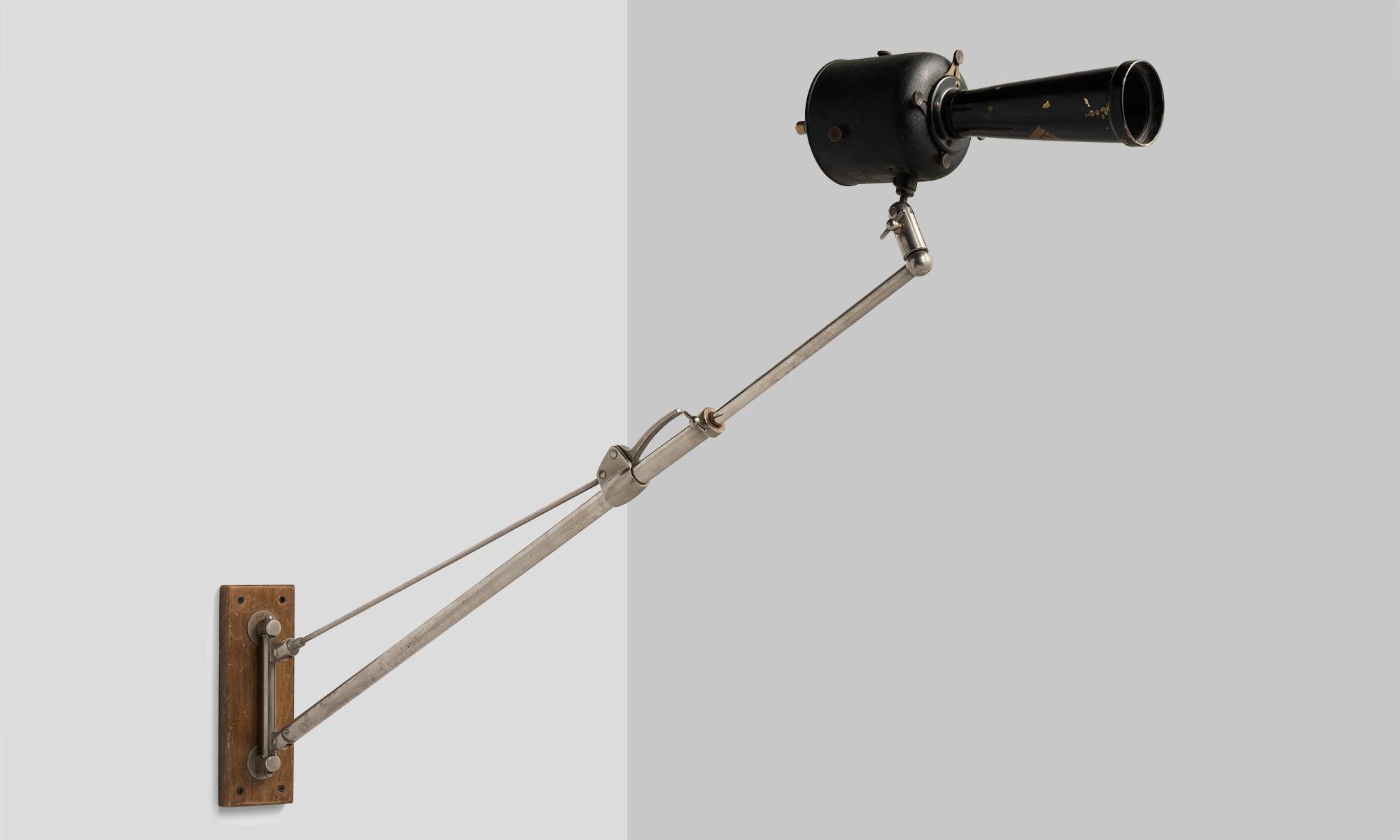 Industrial wall sconce by Reymand Freres & Cie, France, circa 1920.

Unique and rare adjustable fixture originally used in a dentists office. Not pictured is a cloth cord, which connects to the top of the light head.

