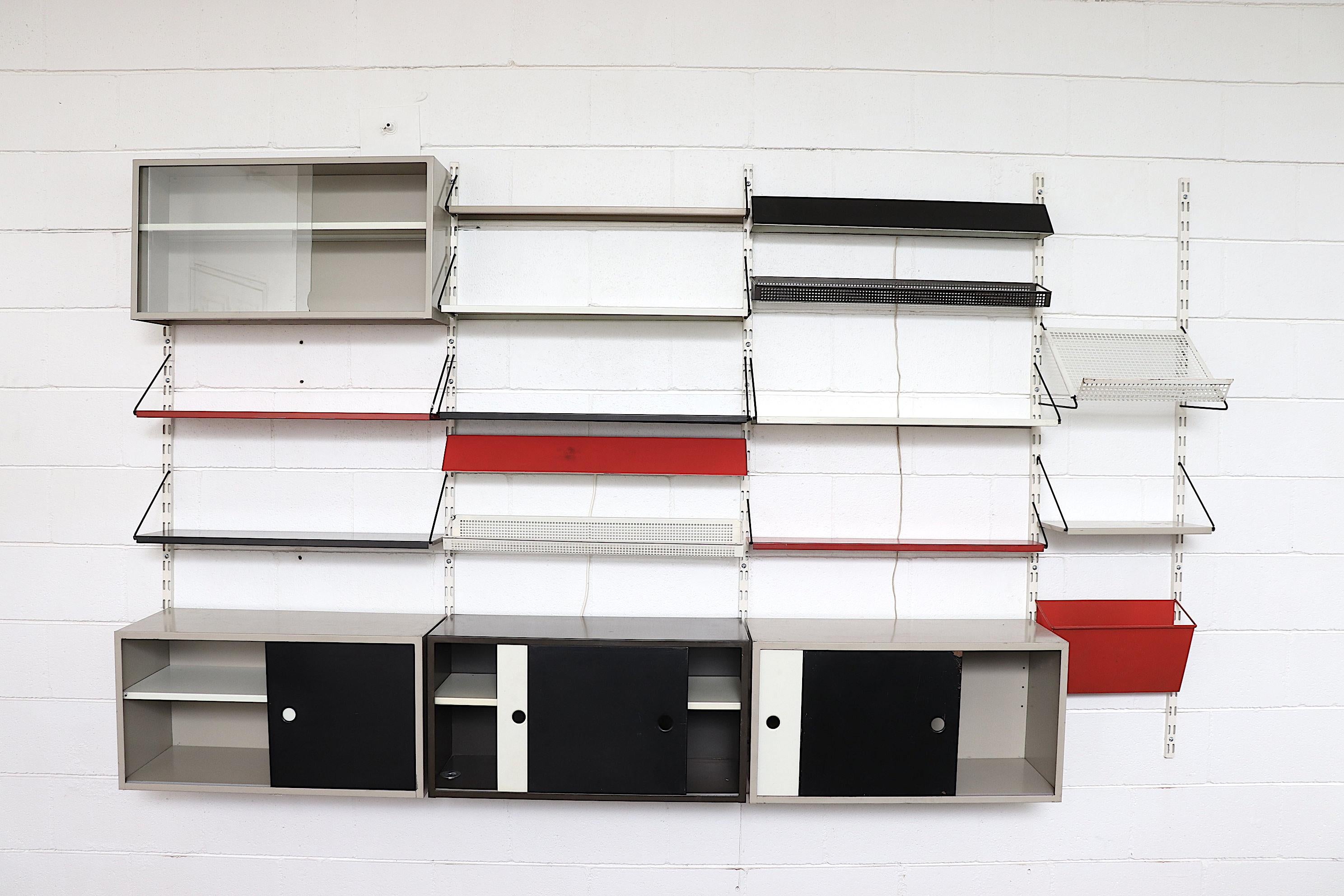 Large 4 Section Pilastro Modular Industrial Wall Unit in Red, White and Black Enameled Metal. The Three Main Sections are Fitted with Adjustable Shelving and Storage Cabinets with Black and White Metal Sliding Doors, a Display Cabinet with Sliding