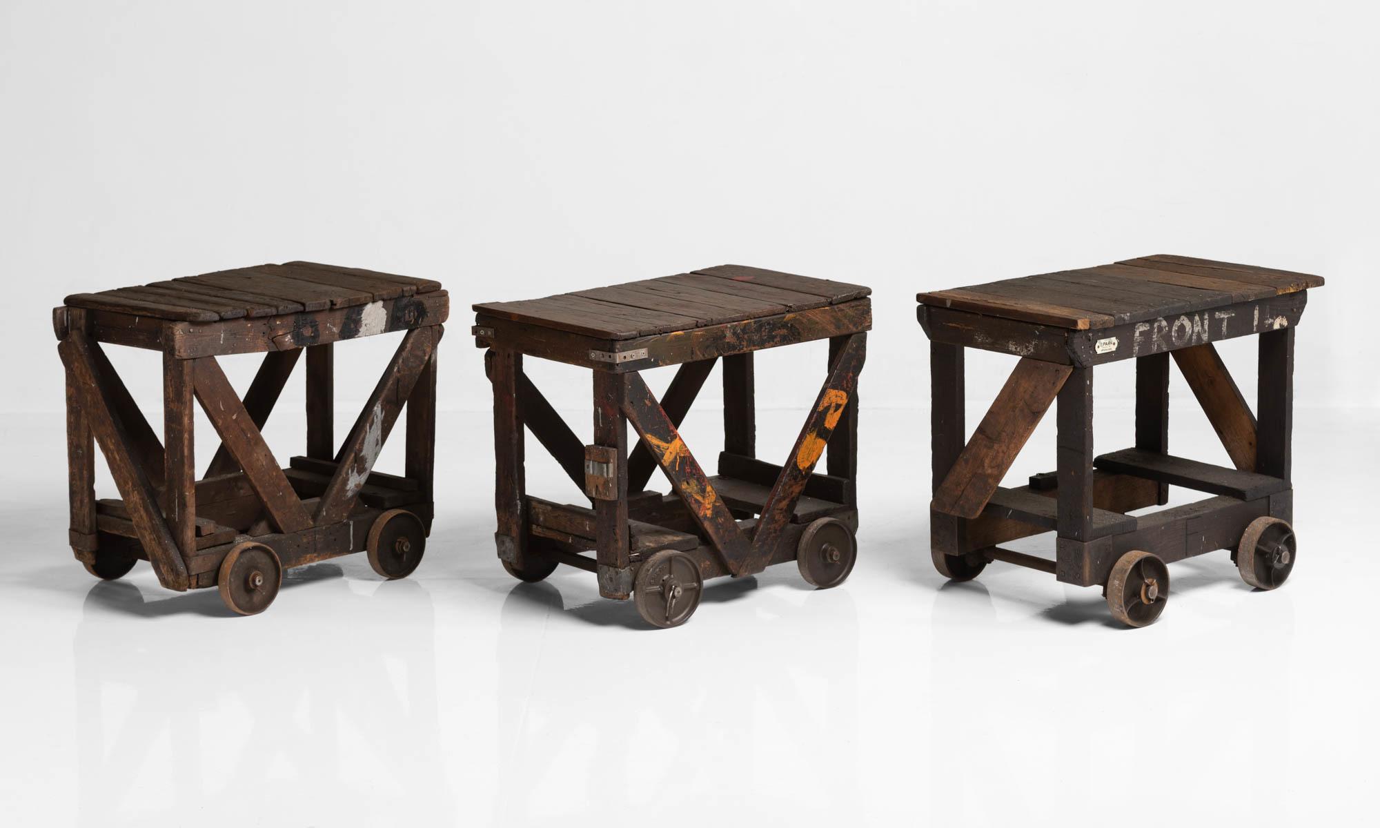 Industrial wheel table, England, circa 1940

Heavily patinated, unique table with solid construction and heavy, functional wheels as a base. Each cart has slight variations in size with some featuring painted elements.