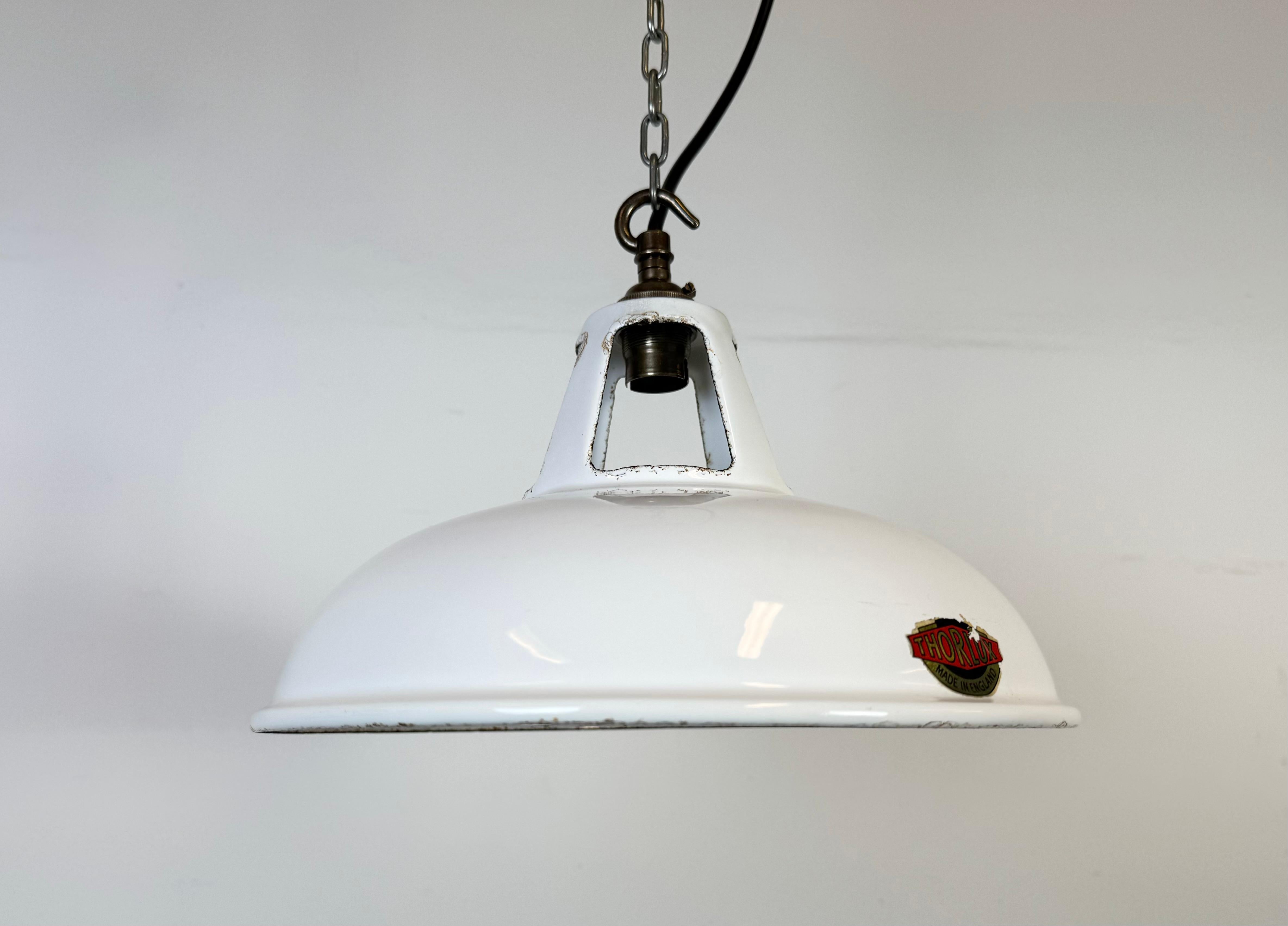 Industrial white enamel factory pendant light made by Thorlux in United Kingdom during the 1960s. White enamel inside the shade. Brass top. The socket requires B22 light bulbs. New wire. The weight of the lamp is 0,7 kg.The diameter of the shade is
