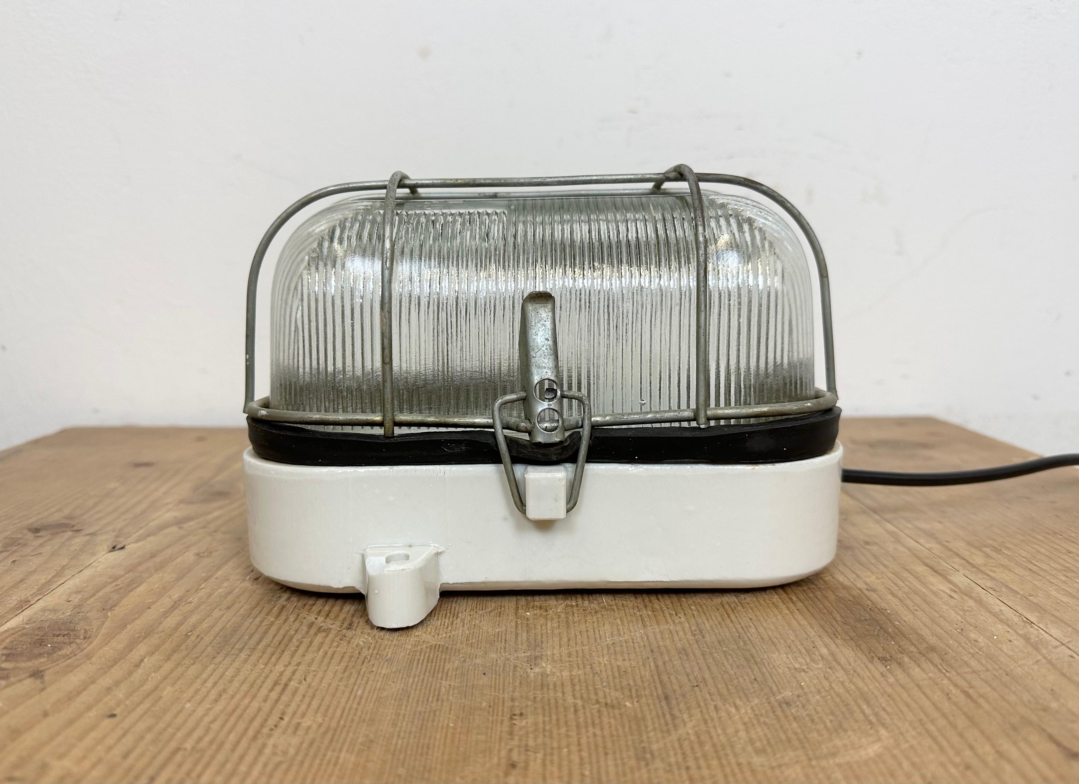 Polish Industrial White Porcelain Cage Wall Light with Ribbed Glass, 1970s For Sale