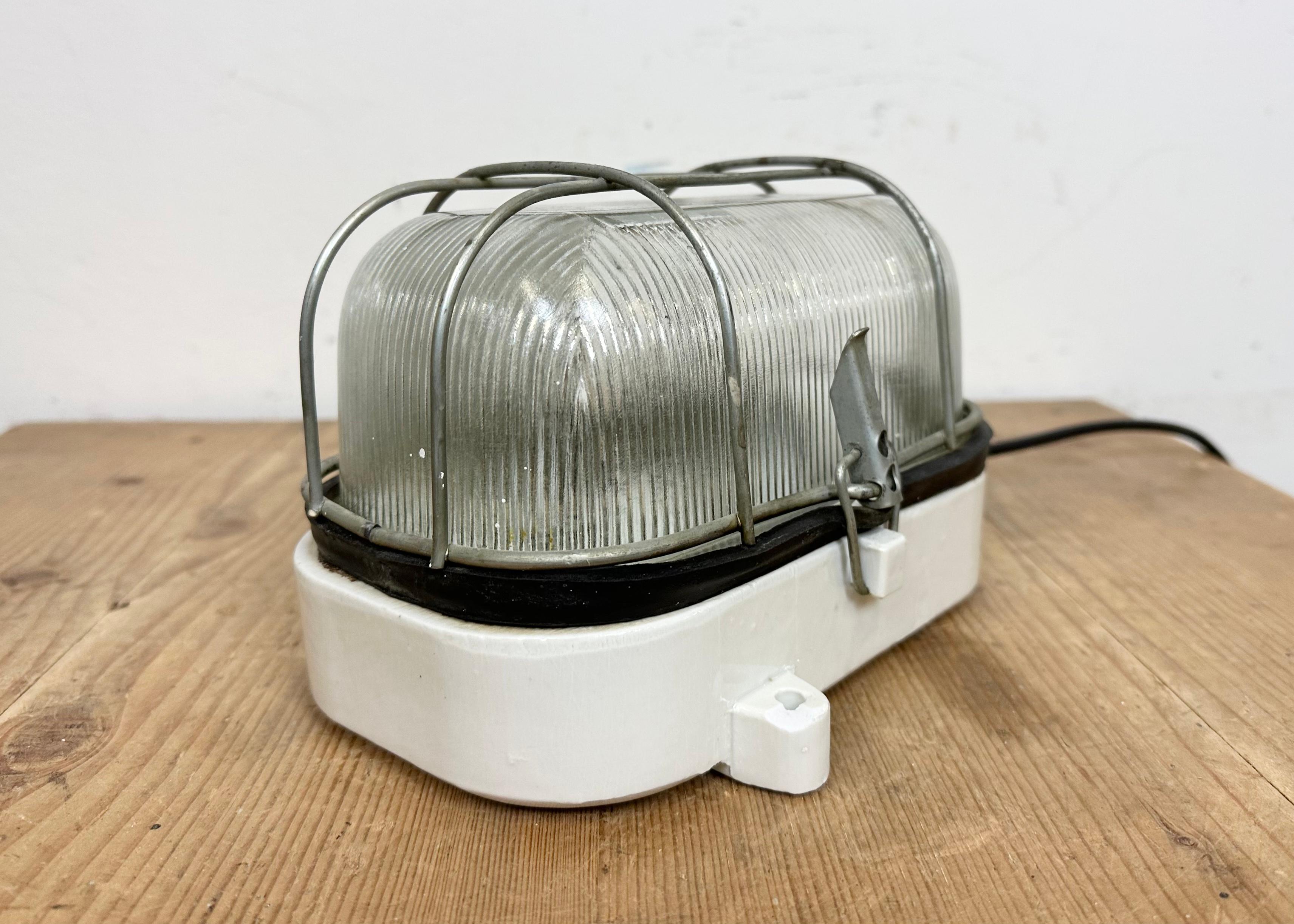 Industrial White Porcelain Cage Wall Light with Ribbed Glass, 1970s In Good Condition For Sale In Kojetice, CZ