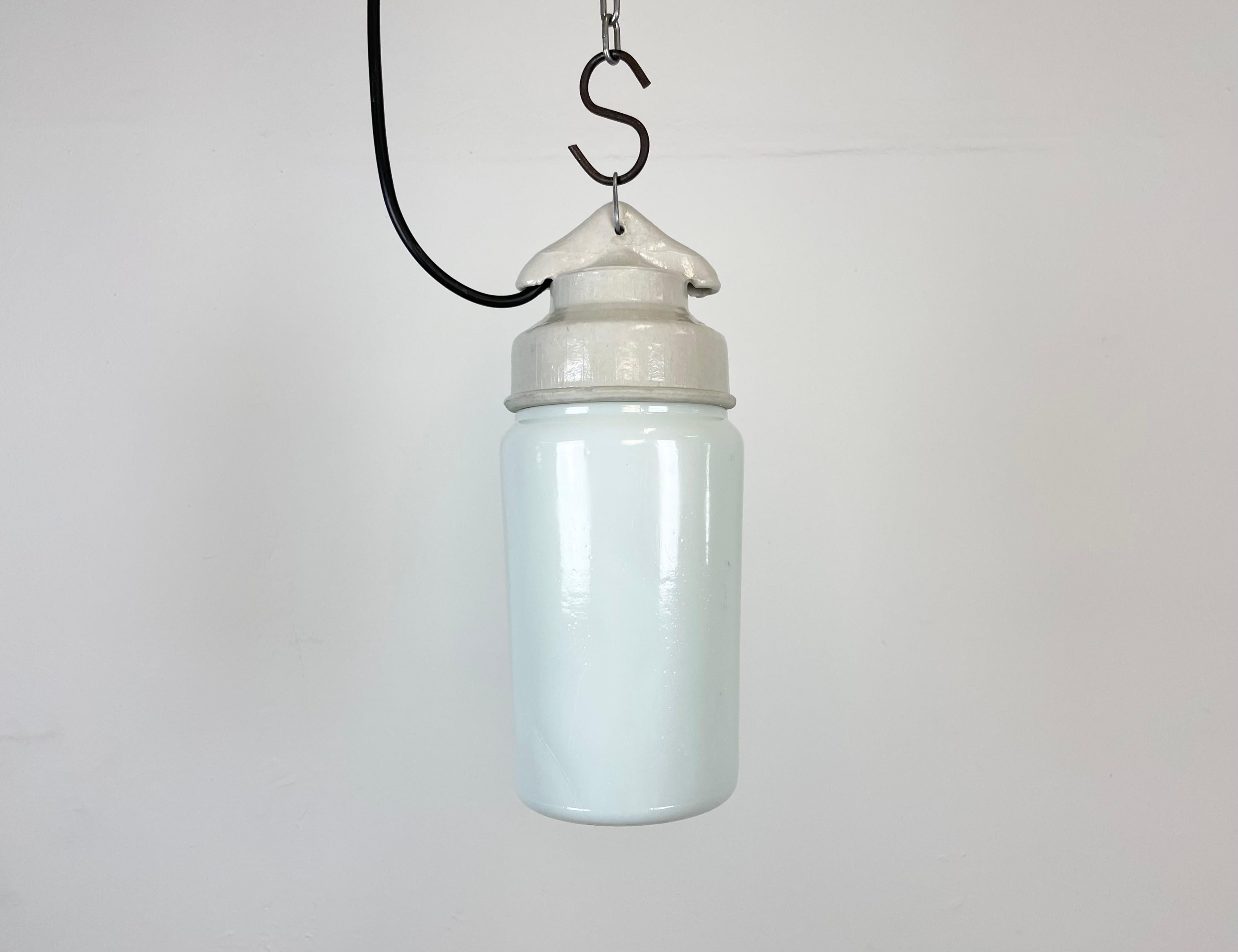 Vintage industrial light made in former Soviet Union during the 1970s.It features a white porcelain top and a milk glass cover. The socket requires E27 light bulbs. New wire. The weight of the lamp is 1kg.