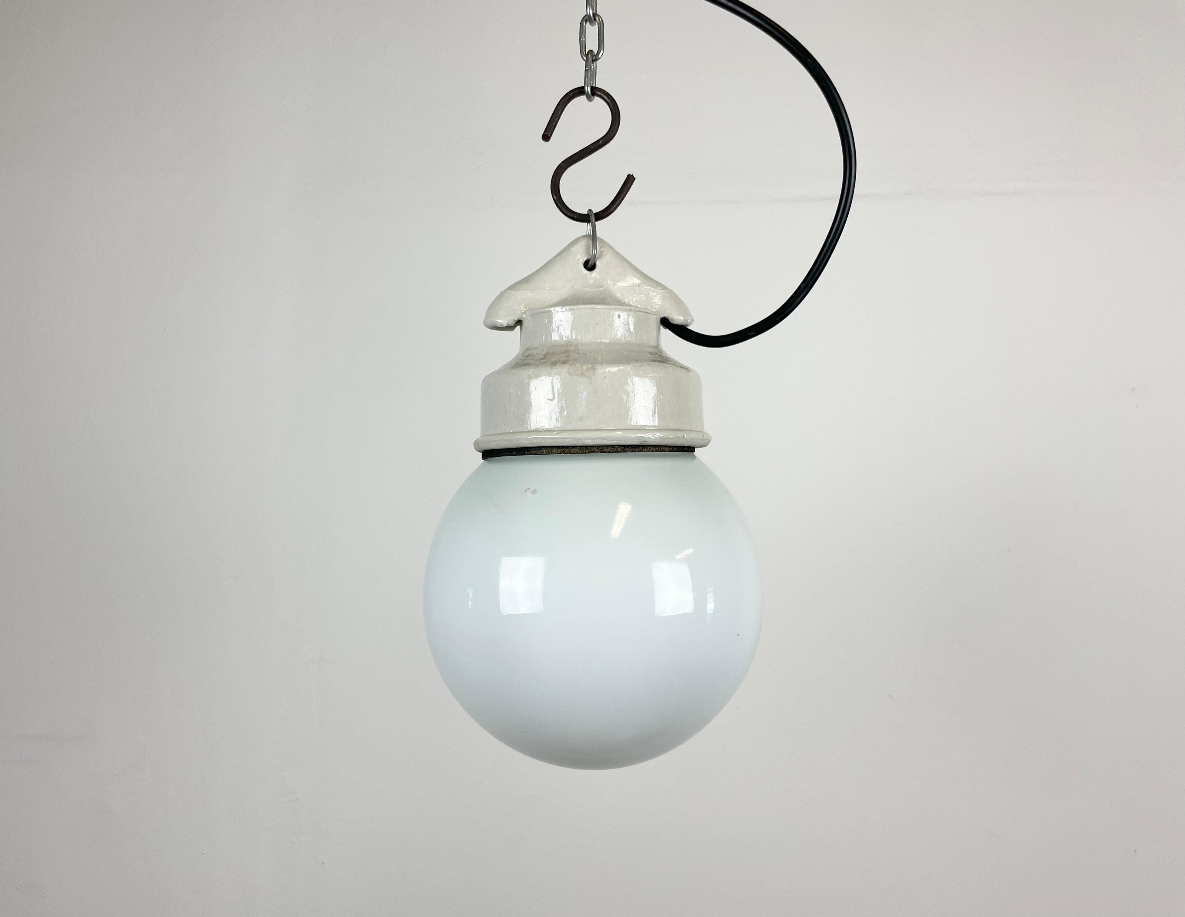 Vintage industrial light made in former Soviet Union during the 1970s.It features a white porcelain top and a milk glass cover. The socket requires E27 light bulbs. New wire. The weight of the lamp is 1kg.