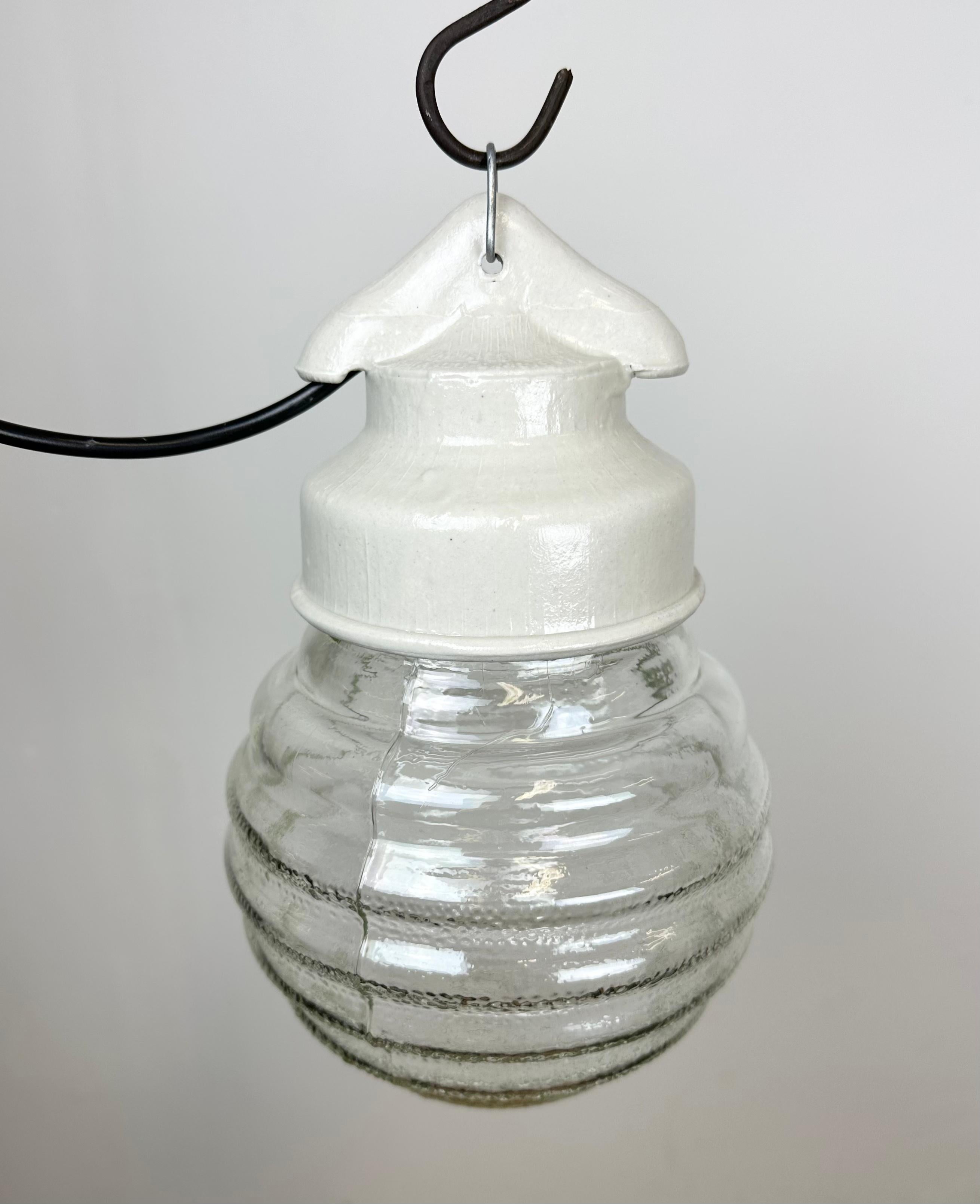 Vintage industrial light made in former Soviet Union during the 1970s.It features a white porcelain top and a ribbed glass cover. The socket requires E27/ E26 light bulbs. New wire. The weight of the light is 1 kg.