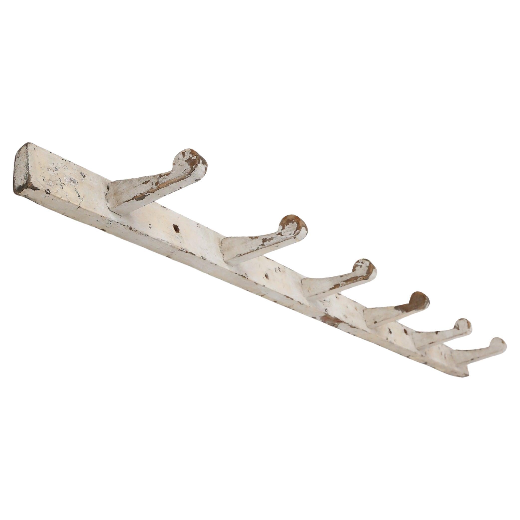 Industrial white wall mounted coat rack in wood, Belgium ca. 1920