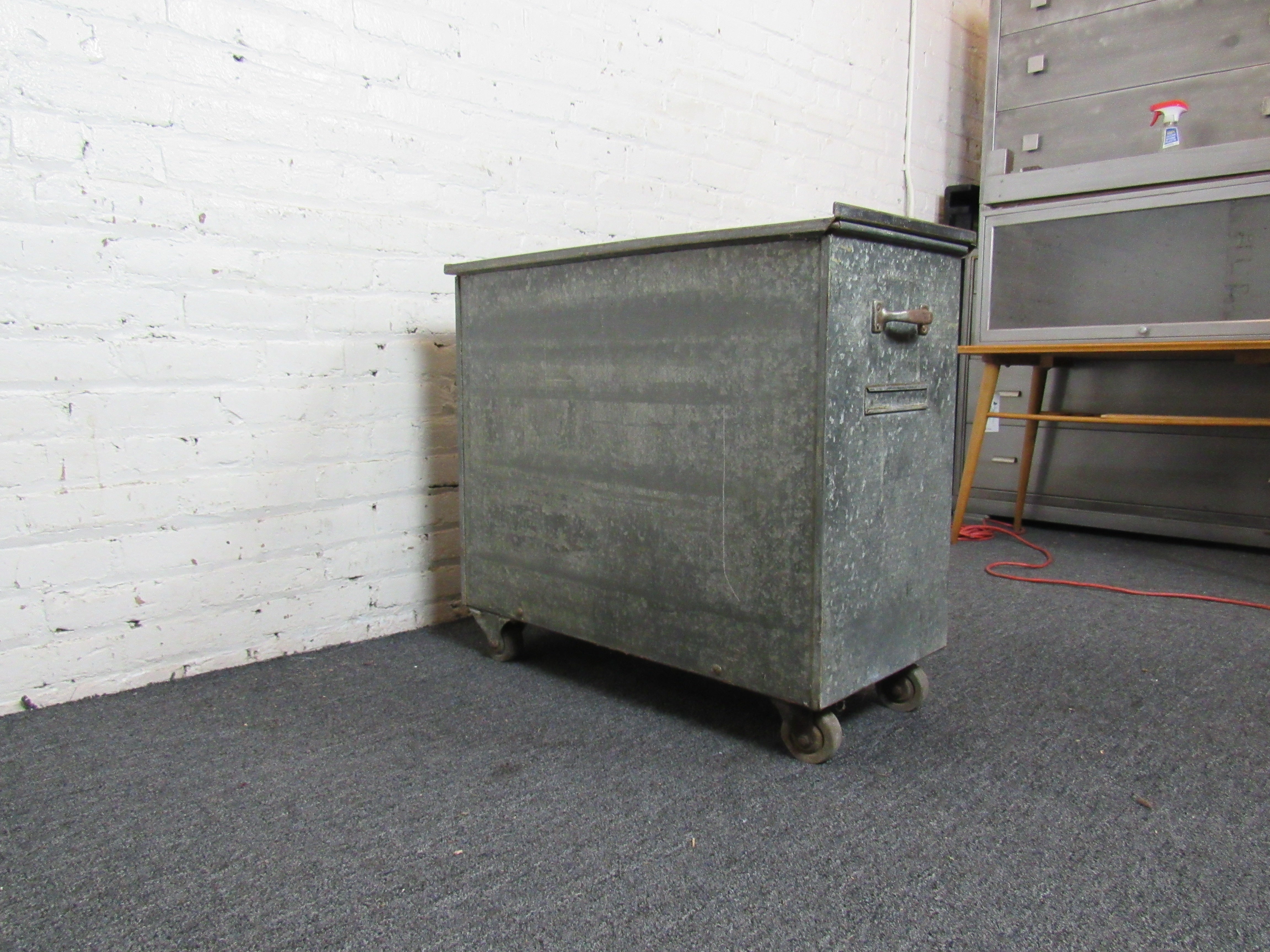 Industrial galvanized tin rolling box made by Wilder. Sliding top reveals a large storage space. Perfect for use in a workshop, or in the home as a unique end table. Please confirm item location with seller (NY/NJ).