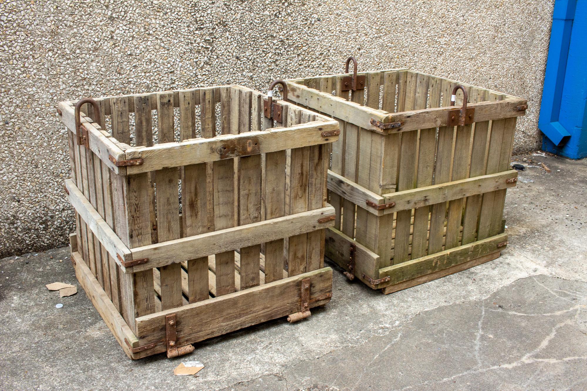 Each of these industrial wood crates is sturdy and crafted in solid wood and iron. They were used in an industrial format and were lifted and moved via chain. They are in good condition, with some patination to the iron present. We imagined them as