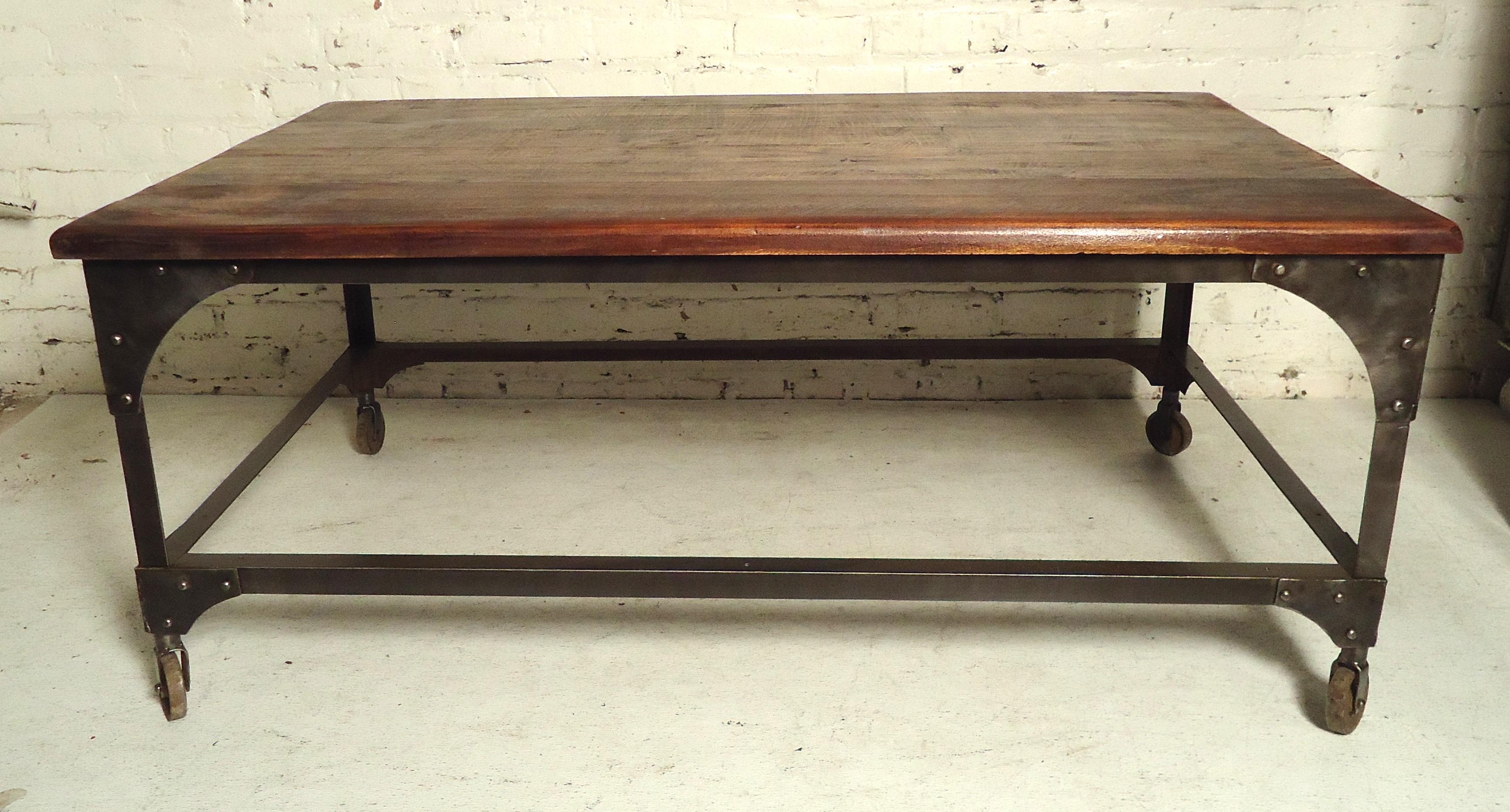 Metal frame base with a solid wood top given a rough rustic look. Exposed rivets and metal casters.

(Please confirm item location - NY or NJ - with dealer).
 