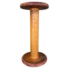 Industrial Wooden Textile Mill Bobbin or Spool with Red Painted Ends.