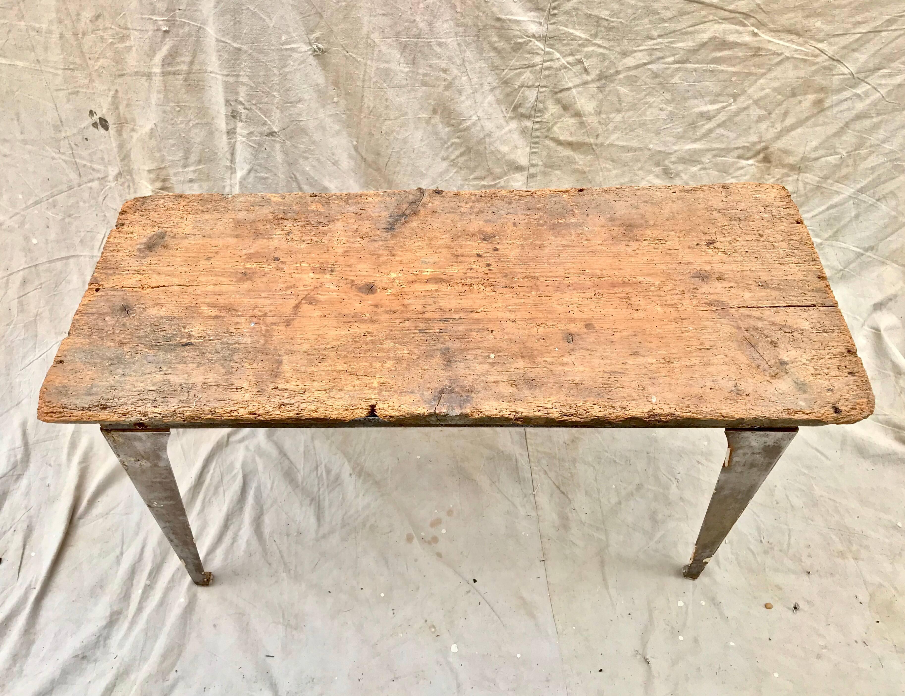A useful and cool looking Industrial workbench of light steel having an added early 19th century pine top. The top adds a tremendous amount of warmth and patina, and allows the piece to also function as an art studio worktable.