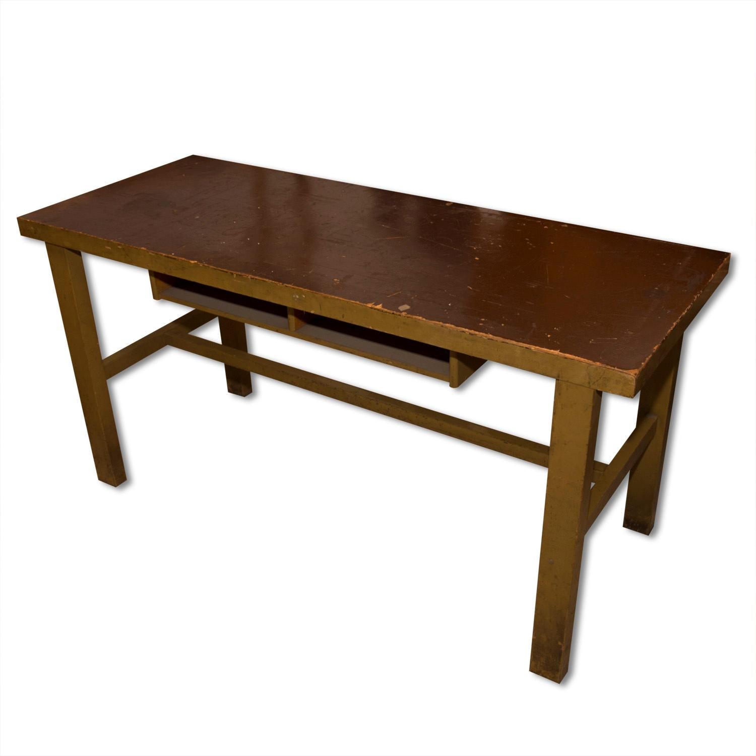 This Industrial workbench was made in the former Czechoslovakia in the 1930s

This desk was originally most likely used as a school desk. Under the tabletop is a divided compartment for documents.

The desk is overall in good vintage condition,