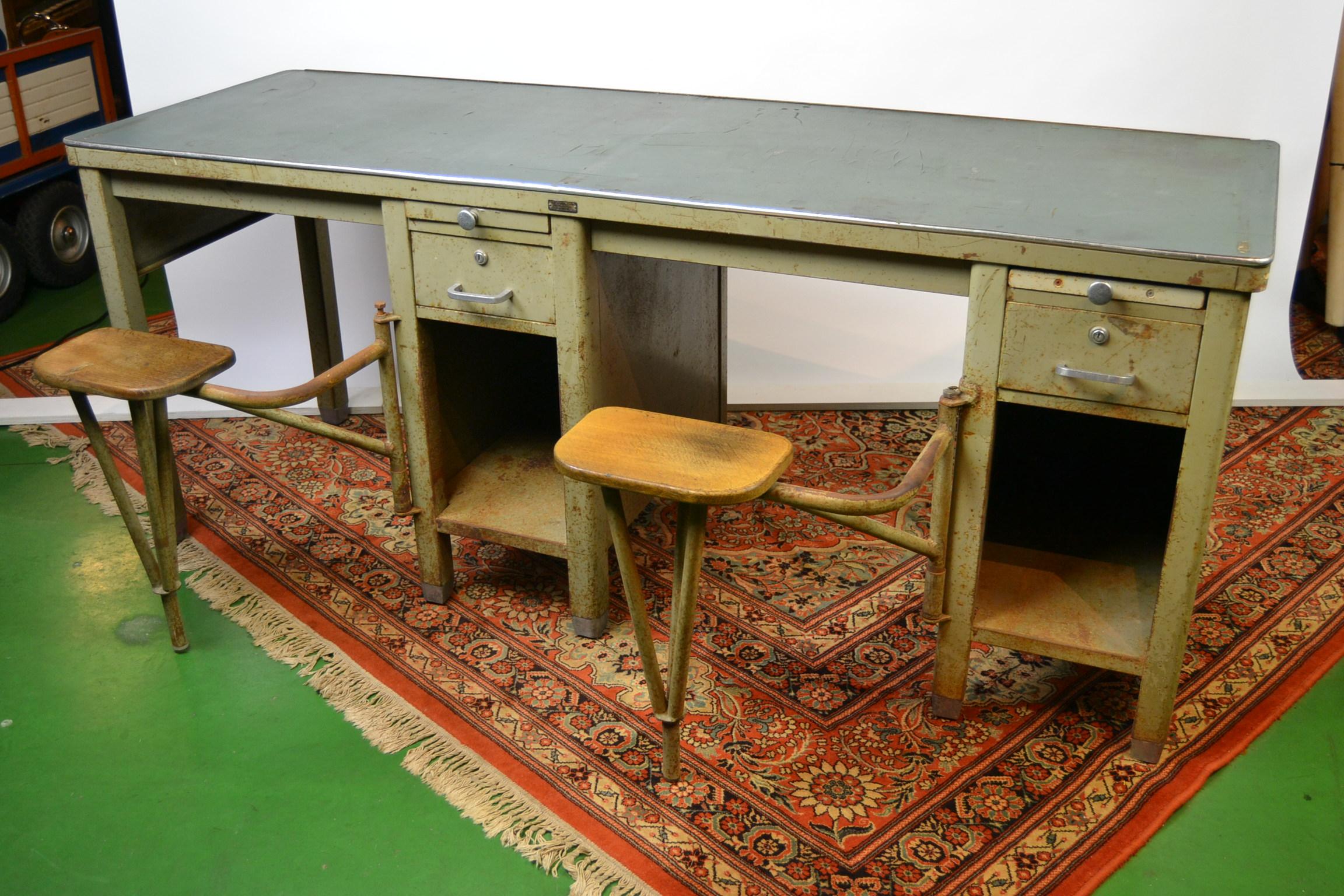 Industrial duo-seat workbench - desk table - work table - factory table
These metal tables with 2 collapsing chairs - swinging swivel stools / seats 
have also 2 drawers and 2 extending working space tablets. 
These were used in factories like