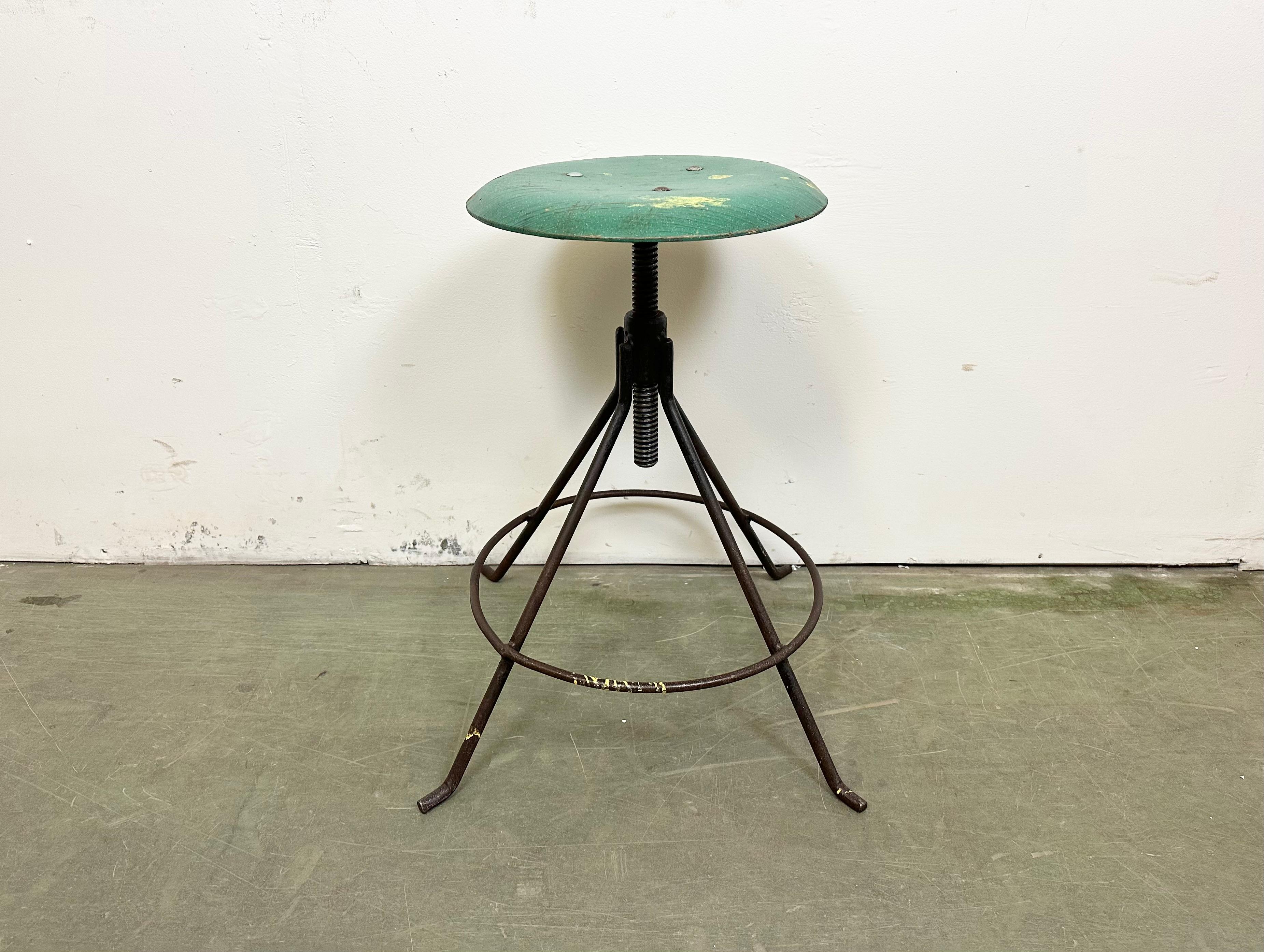 Industrial four-legged height adjustable workshop stool made in Poland during the 1960s.It features a black iron contruction and a green wooden (plywood) seat.
Measures: Min.- Max. seat height: 47 cm - 68 cm.
Seat diameter: 35 cm.
Weight: 6,3 kg