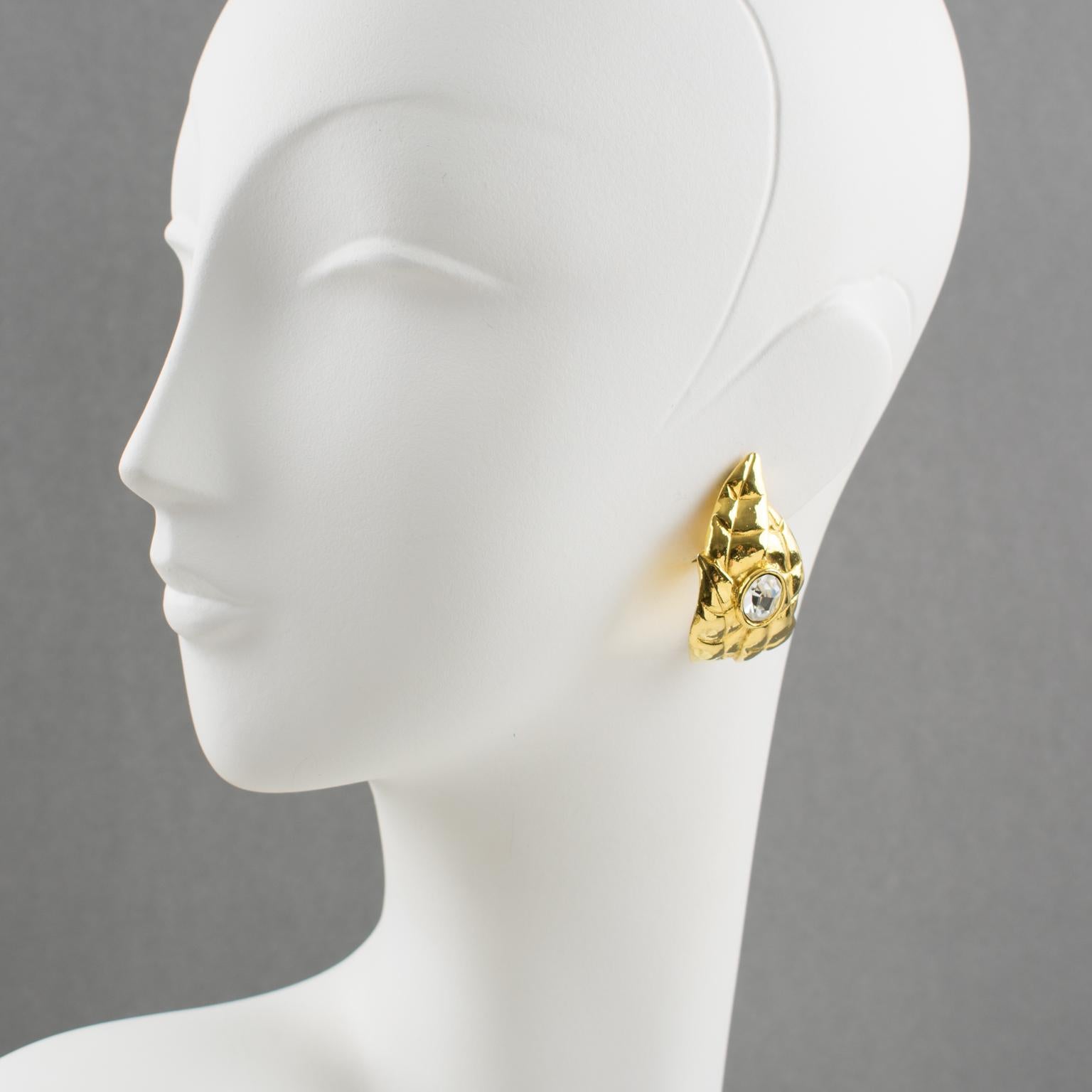 Stunning clip-on earrings by Ines de la Fressange Paris. Hoop shape, with gilt metal all carved and textured featuring oak leaves compliment with a huge clear crystal rhinestone. Signed underside with Ines de la Fressange gilt logo tag: 