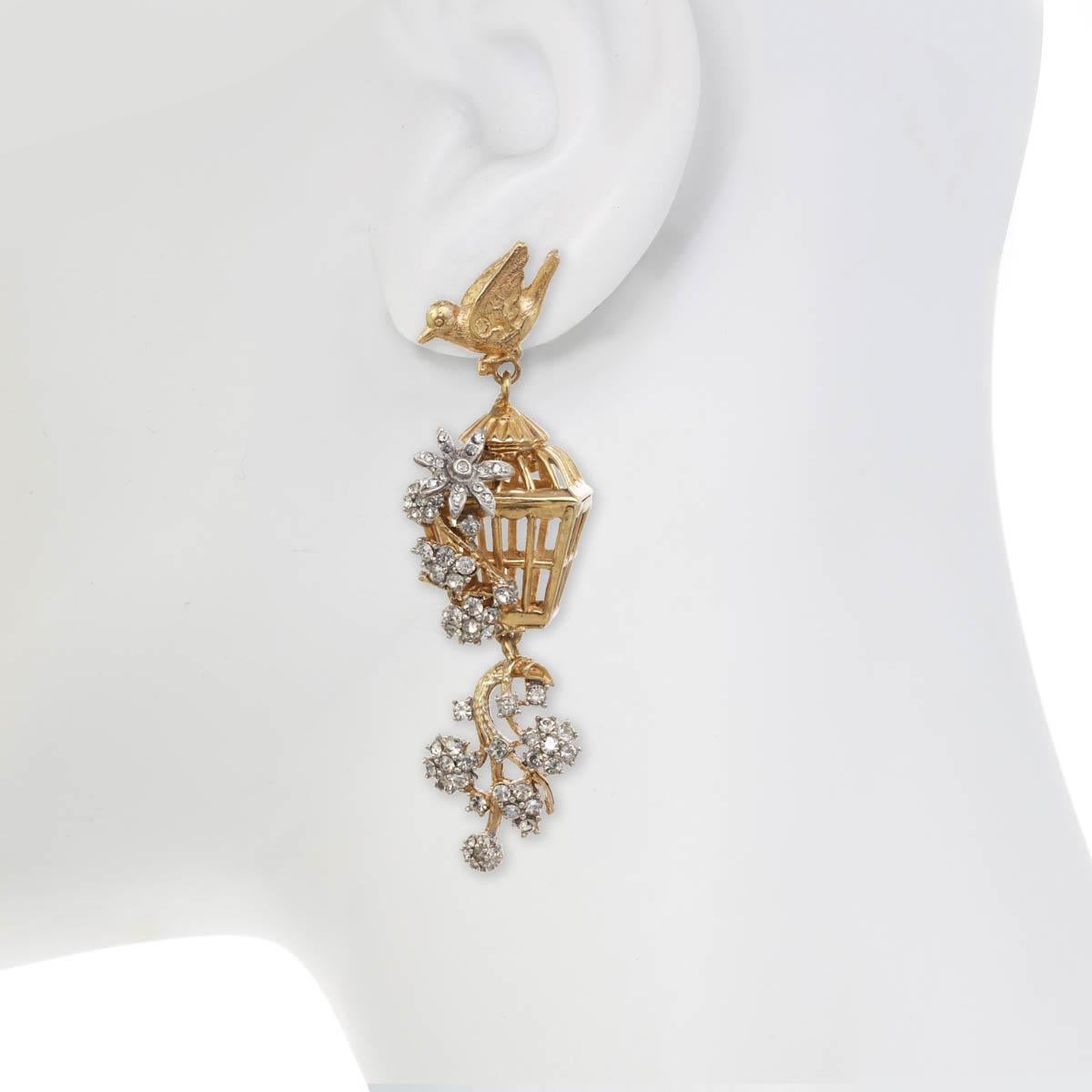 The Romantic Bird Cage Earring, from season I of the Ines x Ciner collaboration, has vintage  glass petals and gorgeous rhinestone accents, offering a glamorous yet amorous statement earring. We love the two-tone look and hope you will too!