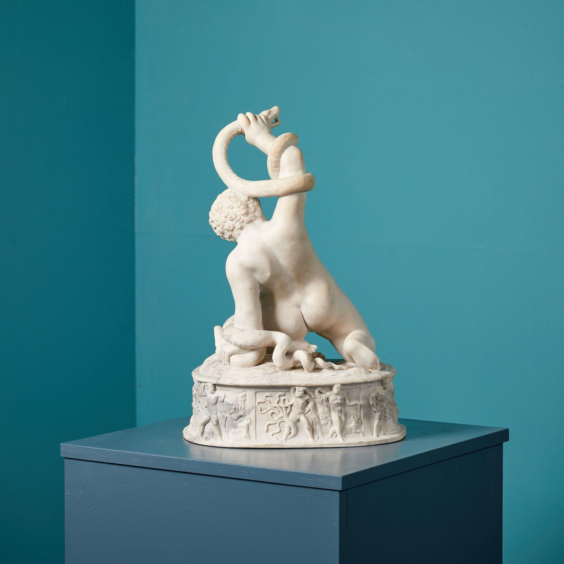Infant Hercules Strangling Two Serpents. A 19th century, composite marble sculpture of the infant Hercules wrestling serpents, one in each hand as he kneels on a tiger skin. The plinth is edged with his ‘labours’.