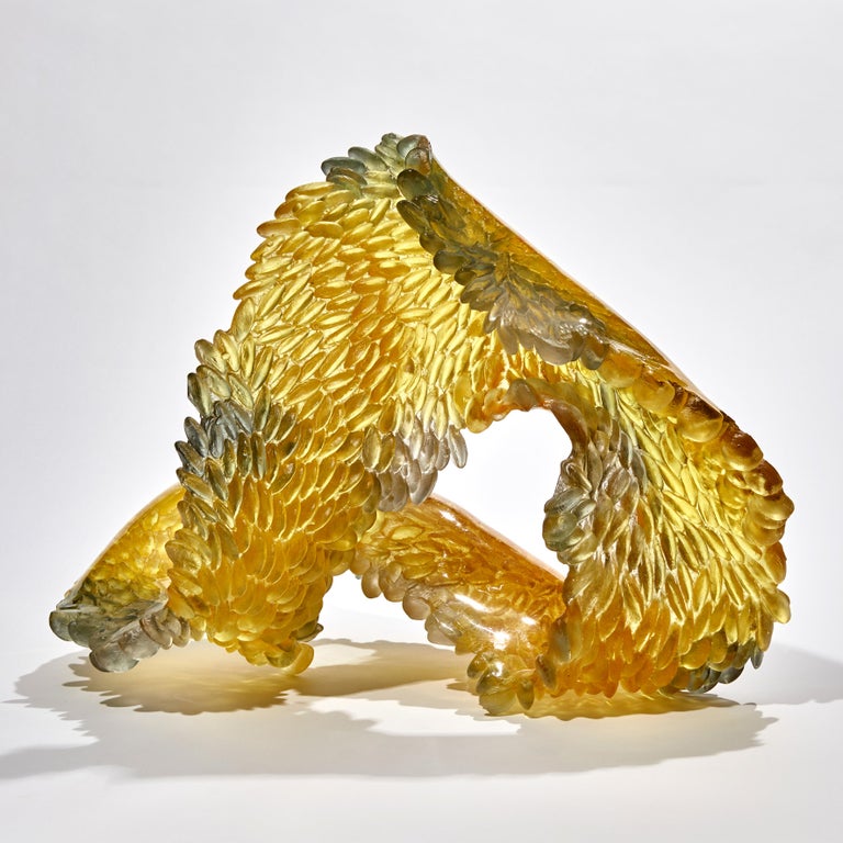 Infinity is a unique textured glass sculpture in amber, gold & grey by the British artist Nina Casson McGarva.

Casson McGarva firstly casts her glass in a flat mould where she introduces all of the beautifully detailed, scaled surface texture,