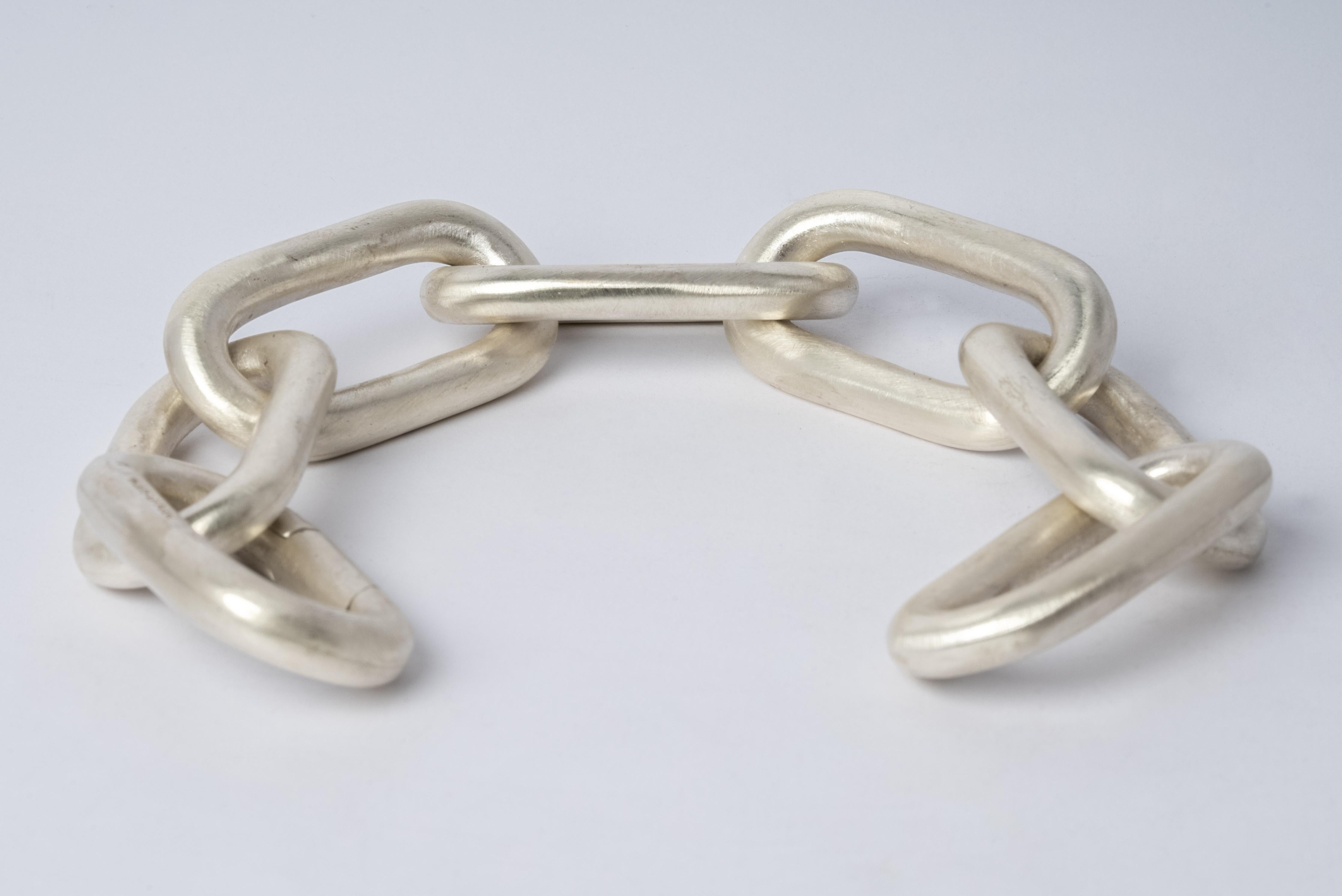Bracelet in matte sterling silver. This piece is 100% hand fabricated from metal plate; cut into sections and soldered together to make the hollow three dimensional form. Dimensions of Chain link size (L × H): 50 mm × 25 mm.