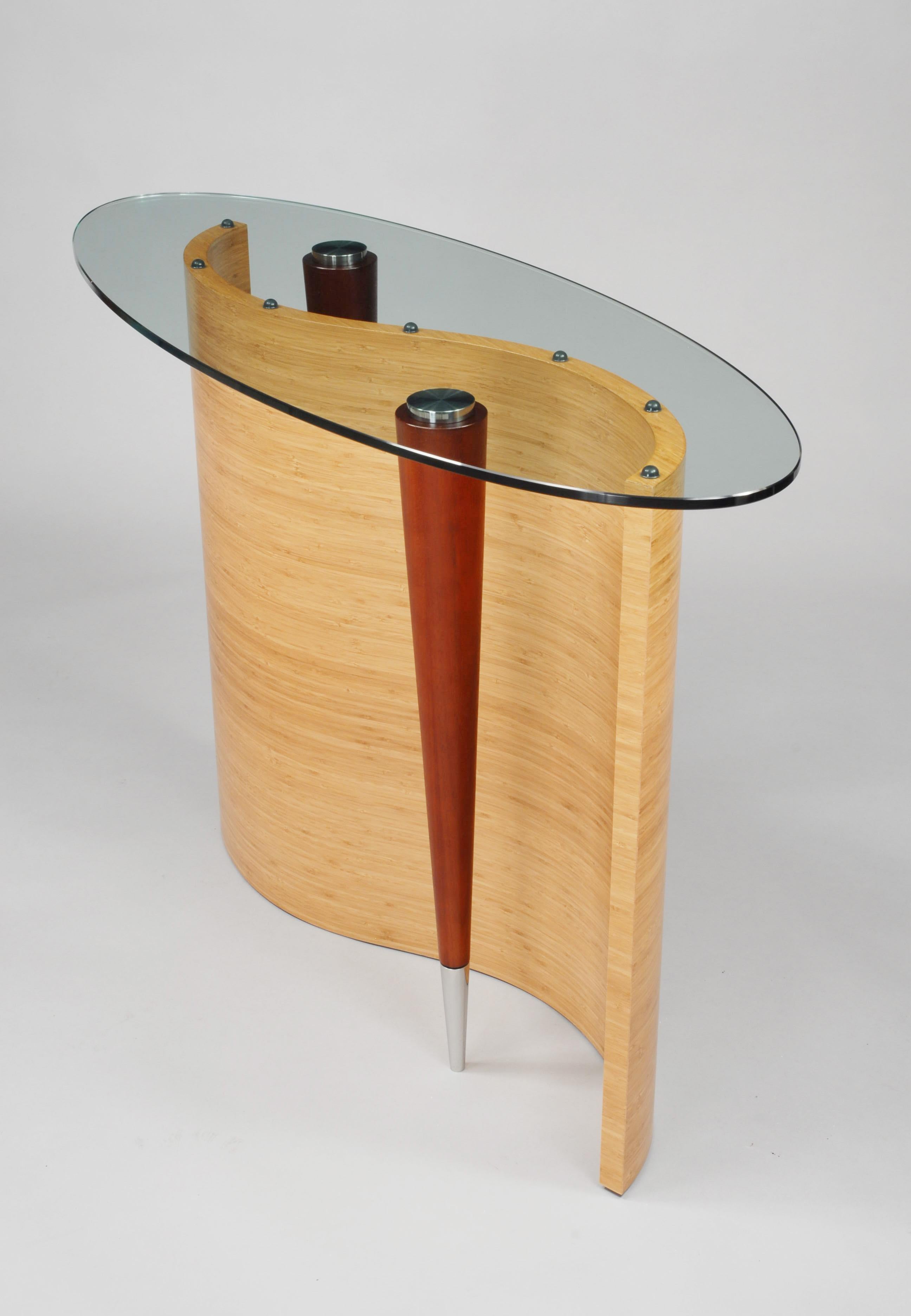 Shown at top with bamboo S-curve base, chestnut Lyptus legs and stainless steel foot detailing. The legs are attache via ultra violet crystal clear glue to the bottom of the glass, giving it the illusion of floating legs.

\All our work is