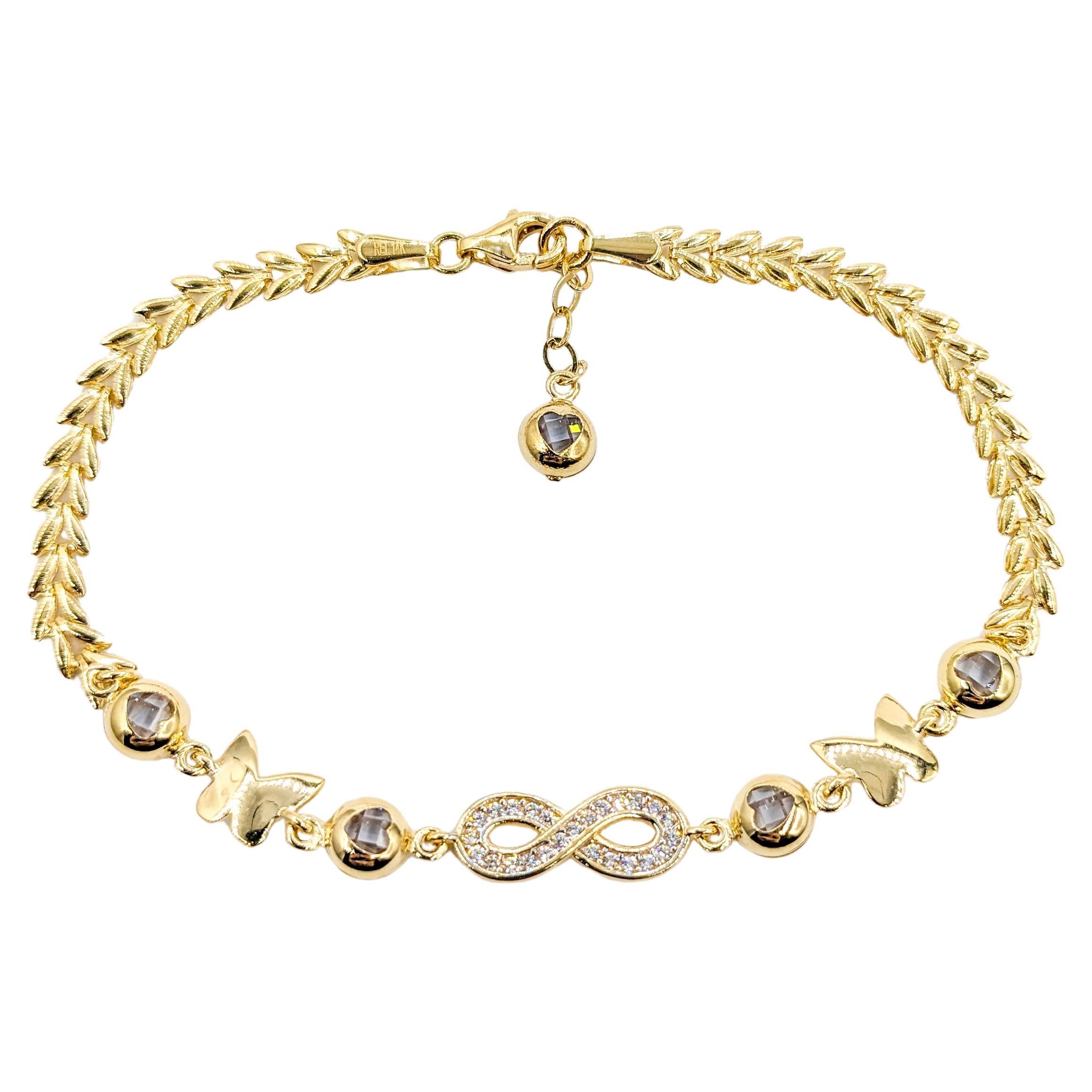 Infinity, Hearts & Butterflies CZ Stone Bracelet In Yellow Gold For Sale
