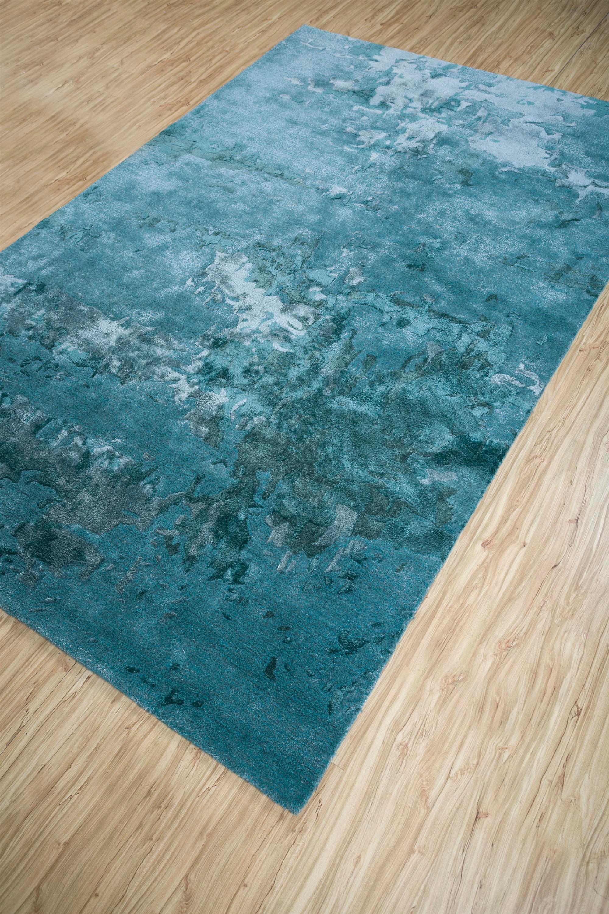 Embark on a celestial journey with this modern hand-tufted rug, a tapestry of the cosmos. Like a masterpiece painting, it envisions an unseen world where pastel hues merge with elusive shapes, forming an abstract marvel. Picture the resilience of