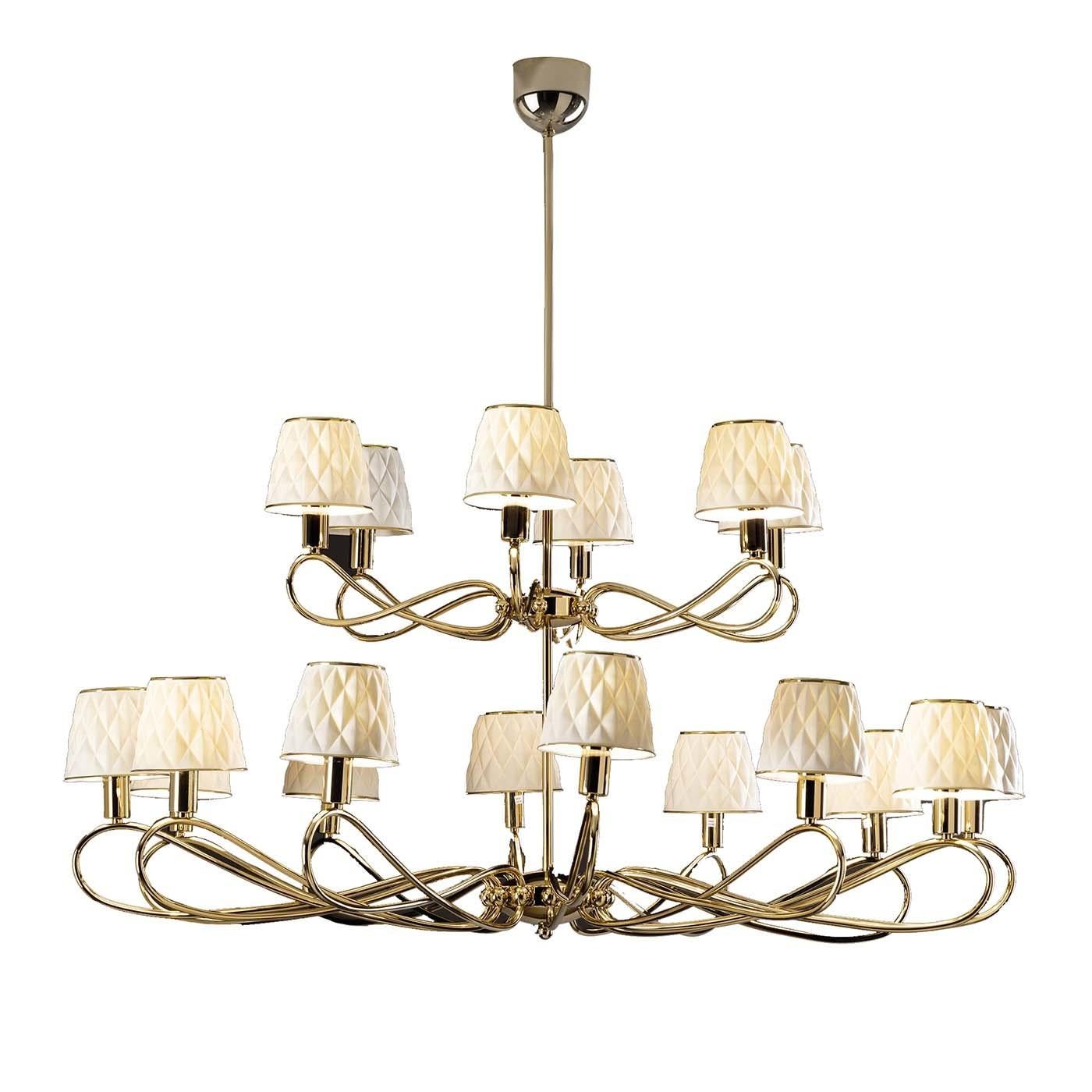 Supported by a sturdy brass frame, this spectacular chandelier strikes with its exceptional elegance. Its tiered silhouette comprises 18 sinuous arms, each sustaining a refined lampshade crafted of matte white porcelain. By folding on themselves,