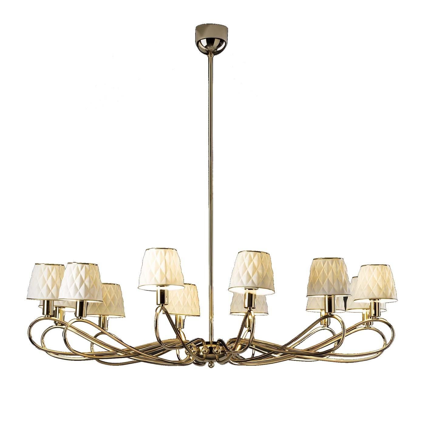 This splendid chandelier conveys an elegant sense of movement with its fascinating design. Hanging from a straight brass frame, twelve sinuous metal arms with an antiqued gold finish sustain as many lampshades. The diffusers are in prized matte