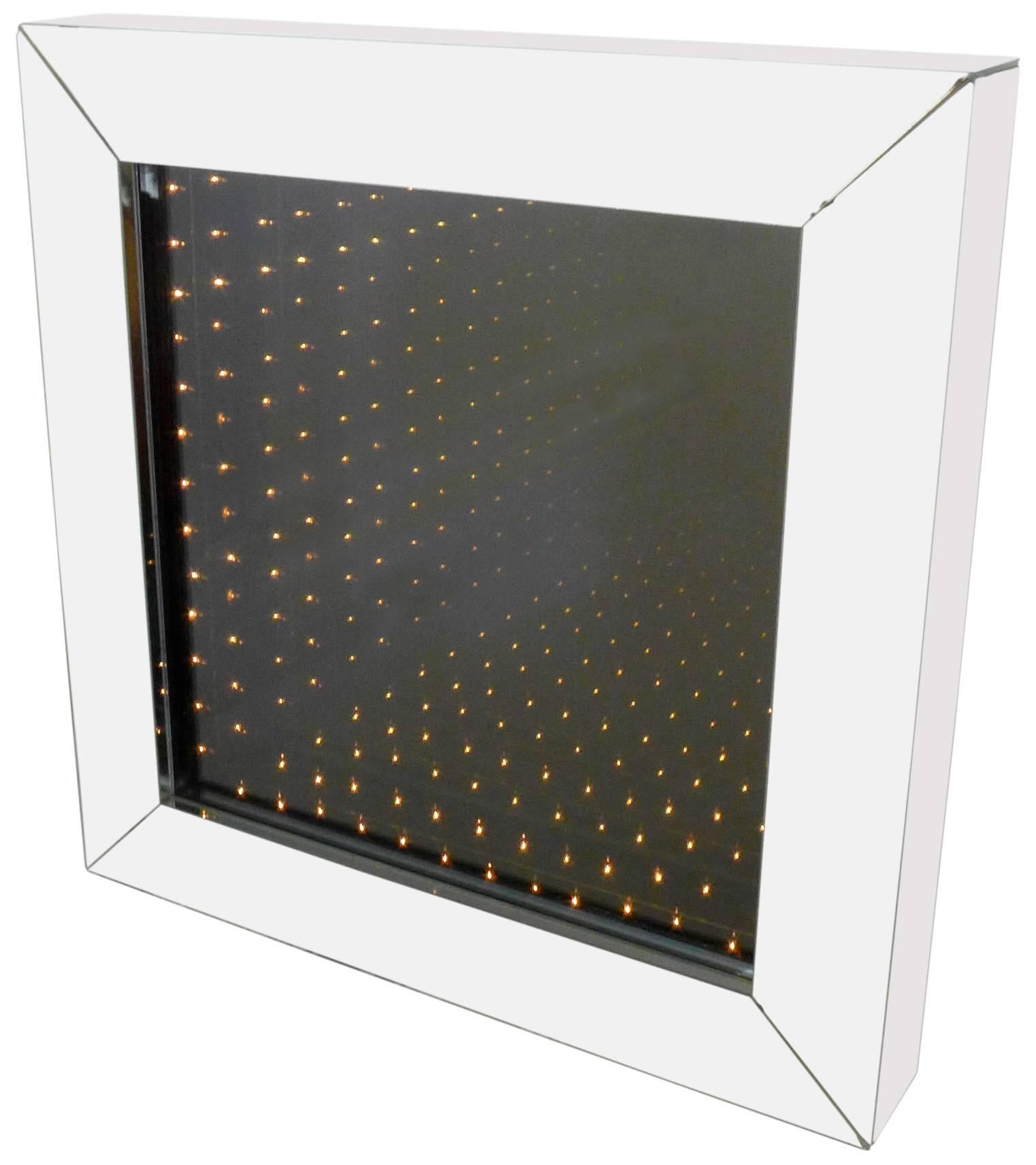 A large and visually alluring infinity mirror in a deep, mirrored box frame. Great scale and construction with a wonderful optical effect, suggesting infinite rows of lit bulbs. A very special decorative accessory that will add another dimension to