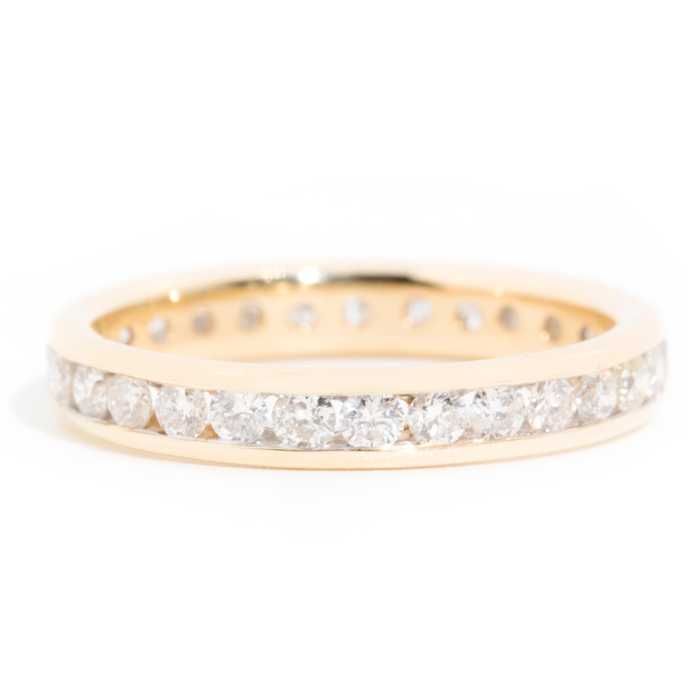 Forged in 9 carat yellow gold, this charming vintage infinity set band ring features a continuous row of sparkling round brilliant diamonds. Simple yet alluring, this lovely piece has been named The Winnie Ring. She is perfectly suited to wear on