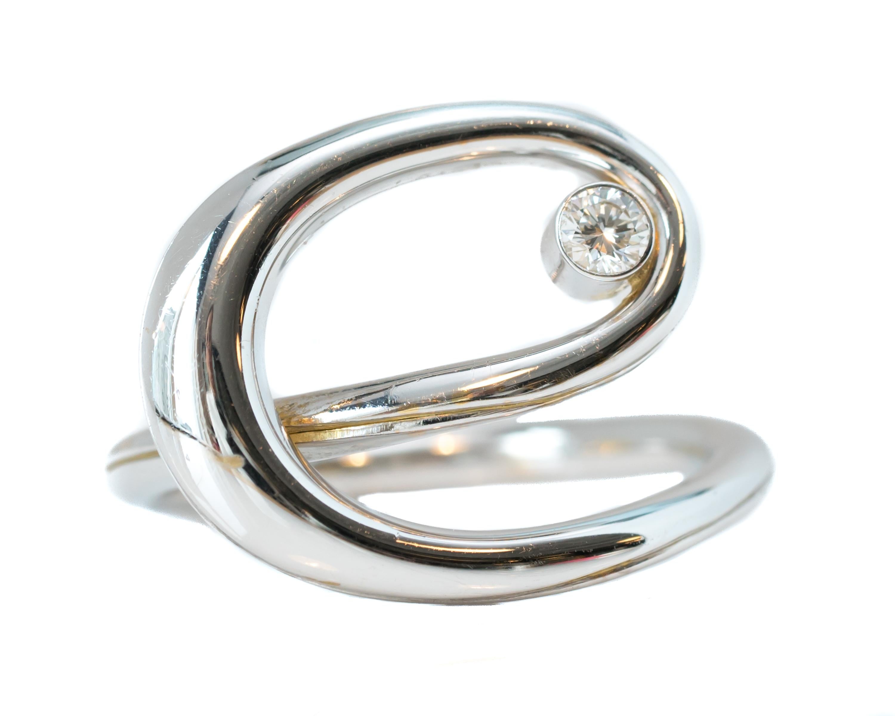 Diamond Swirl Infinity Ring - 18 karat White Gold and Diamond

Features:
0.15 carat Ideal cut Round Brilliant Diamond crafted in 18 karat White Gold. The diamonds are bezel set. 
Infinity Swirl Design - very Unique, Modern, Contemporary Design

Ring