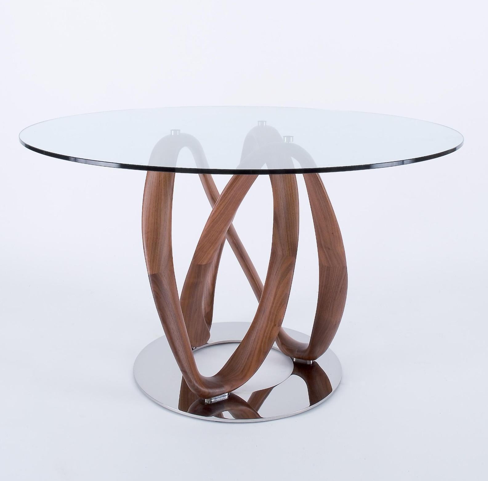 Infinity table, Stefano Bigi for Porada
A solid walnut and round crystal top
75cm x 130cm
very good condition

When a young Milan-based designer, Stefano Bigi, approached Porada with his design for the ‘Infinity’ table in 2009, just four years