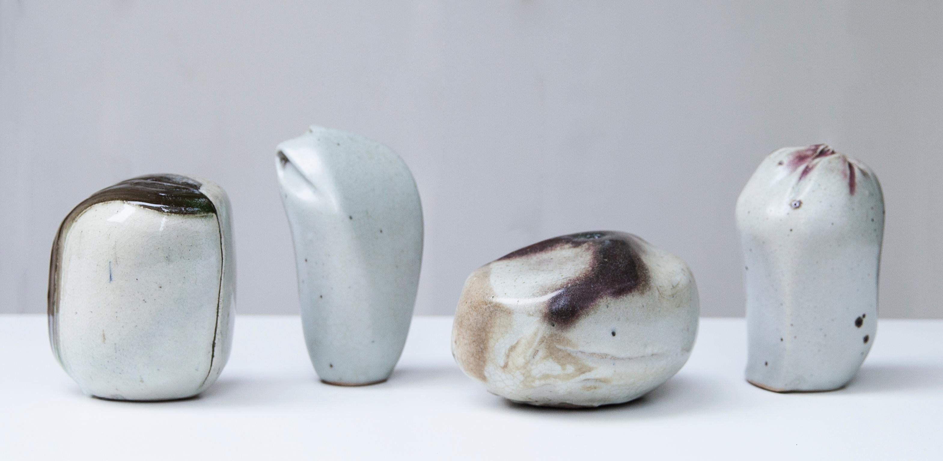 Four unique stoneware sculptural form objects with semi gloss glaze in white, red and brown. 
Heights 15, 14,5, 12 and 9 cm
Impressed monogram
15 D x 12 W x 9 H cm.
  