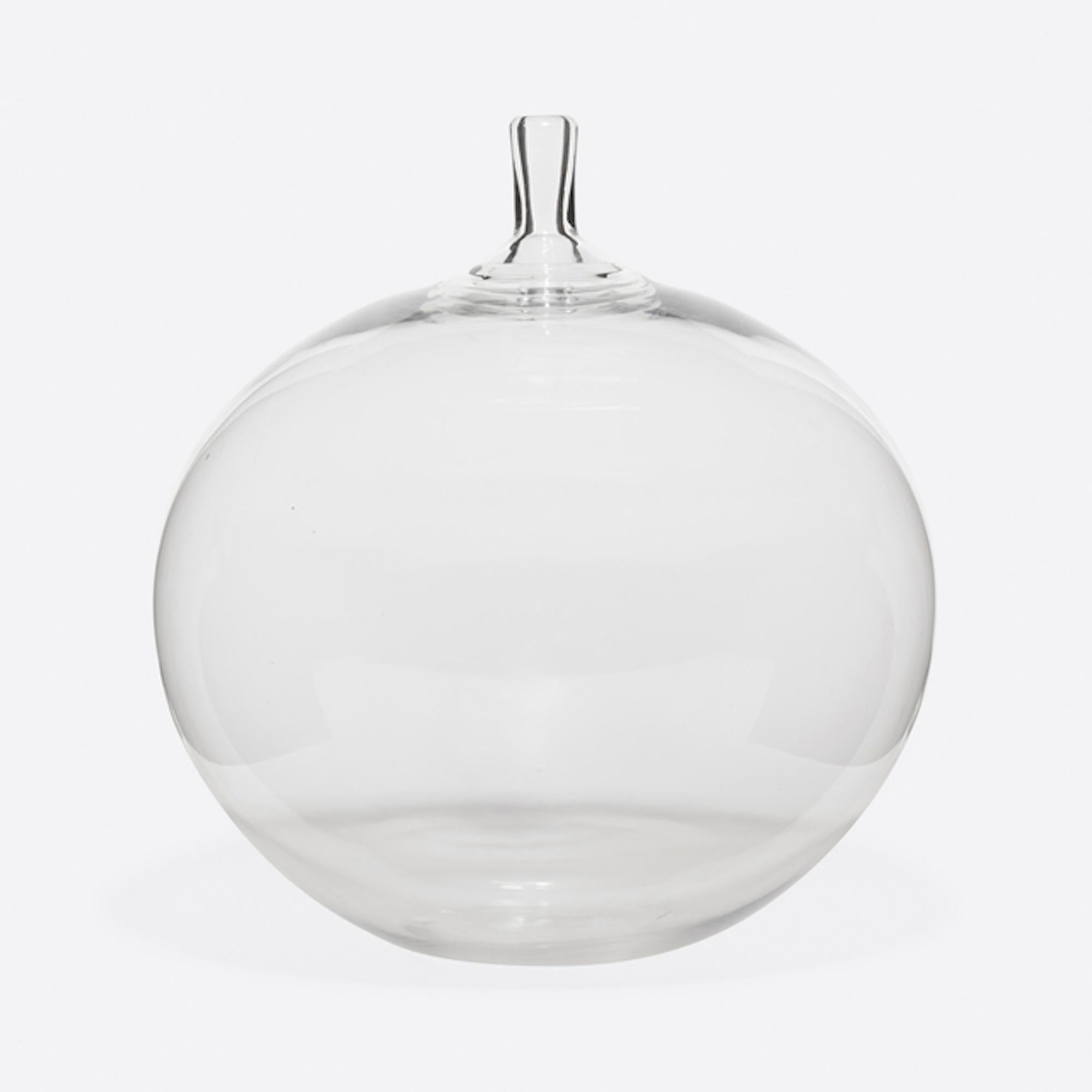 Mid century glass artist Ingeborg Lundin's glass apple vase was made for Orrefors Glassworks. It's a hand blown clear glass vase designed for Milan Triennial Exhibition in 1957. Orrefors believes this piece is one of the best illustrations of the