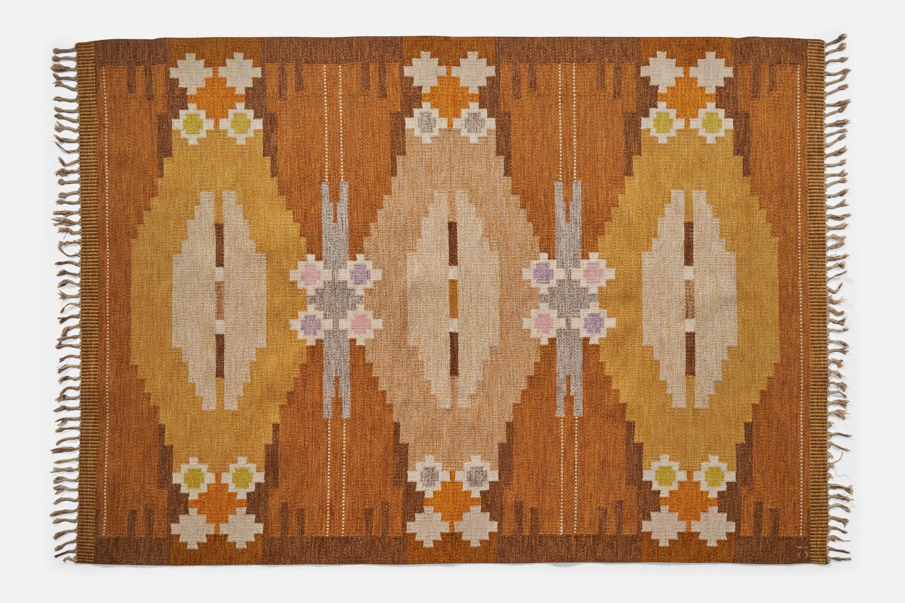 An orange, brown and yellow-dyed flatweave wool carpet designed and produced by Ingegerd Silow, Sweden, c. 1950s.