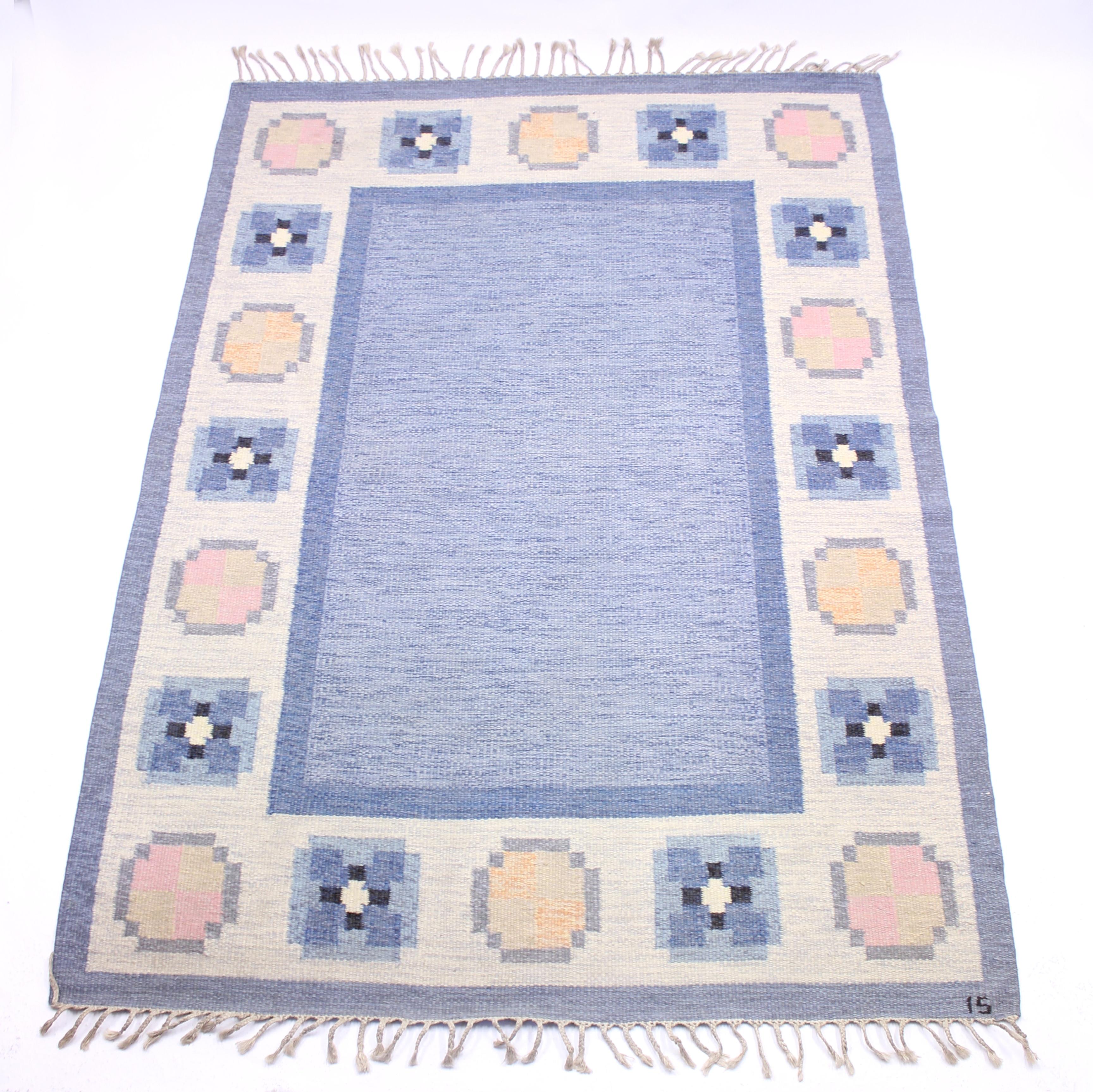 Flat weave Röllakan carpet designed by Ingered Silow in the 1950s. Main colours are blue and white with a dose of pink, black and yellow. Newly cleaned by a professional carpet cleaning company. Very good vintage condition with minimal ware